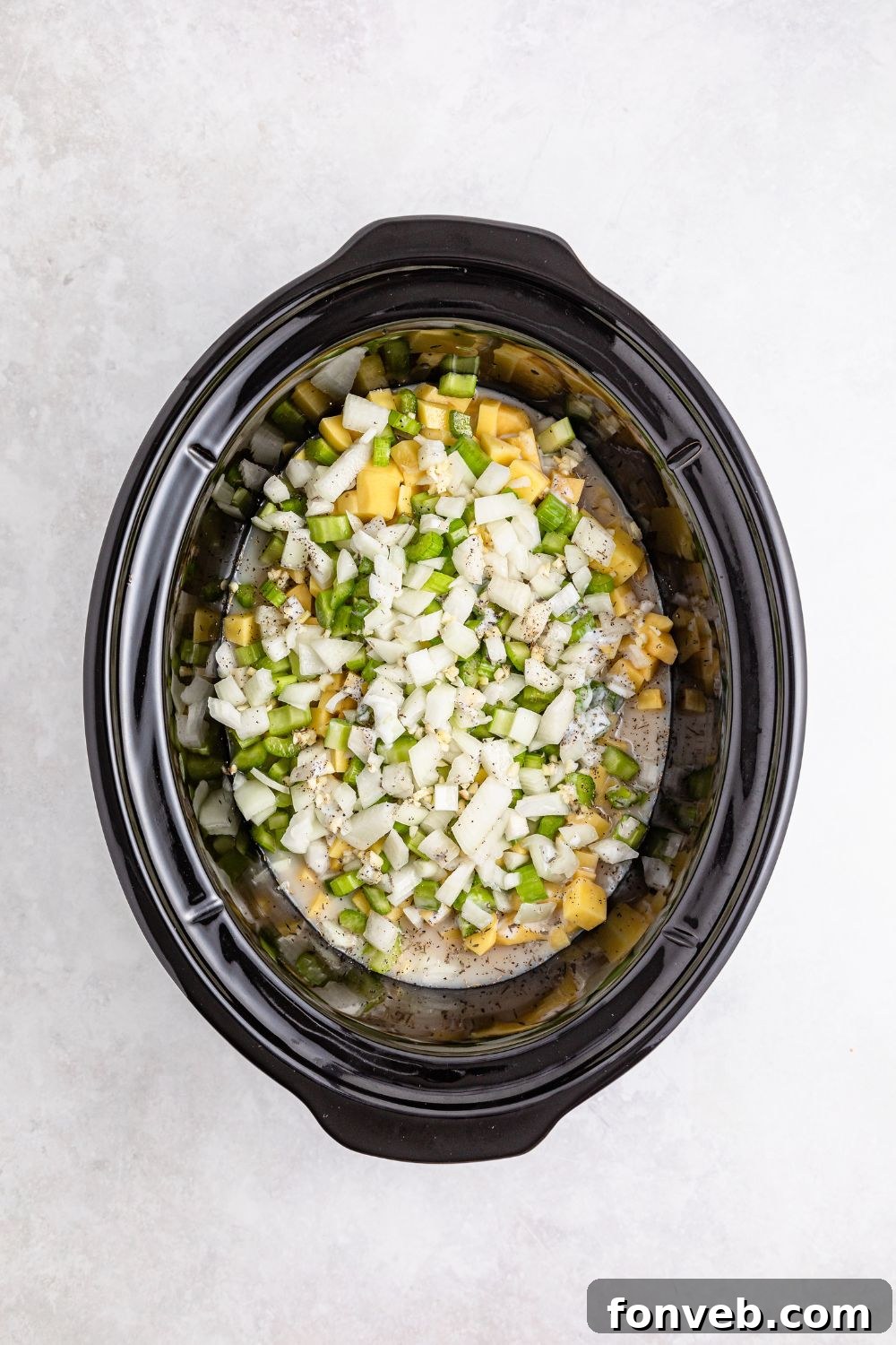 Easy Slow Cooker Chicken Pot Pie 9 raw slow cooker pot pie ingredients in slow cooker on table