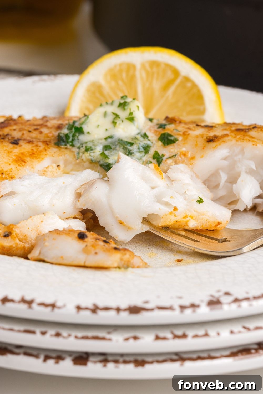 Golden Pan-Seared Tilapia 4 Pan Fried Tilapia on plate with a lemon wedge on side