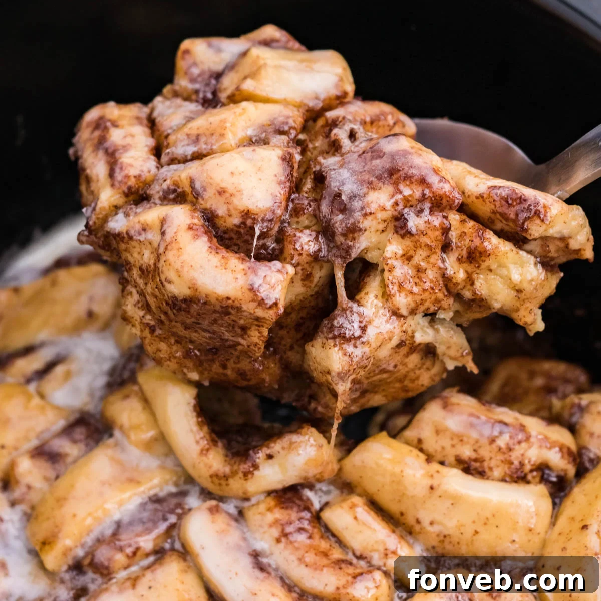 Close up view of the casserole being served using a large silver spoon 