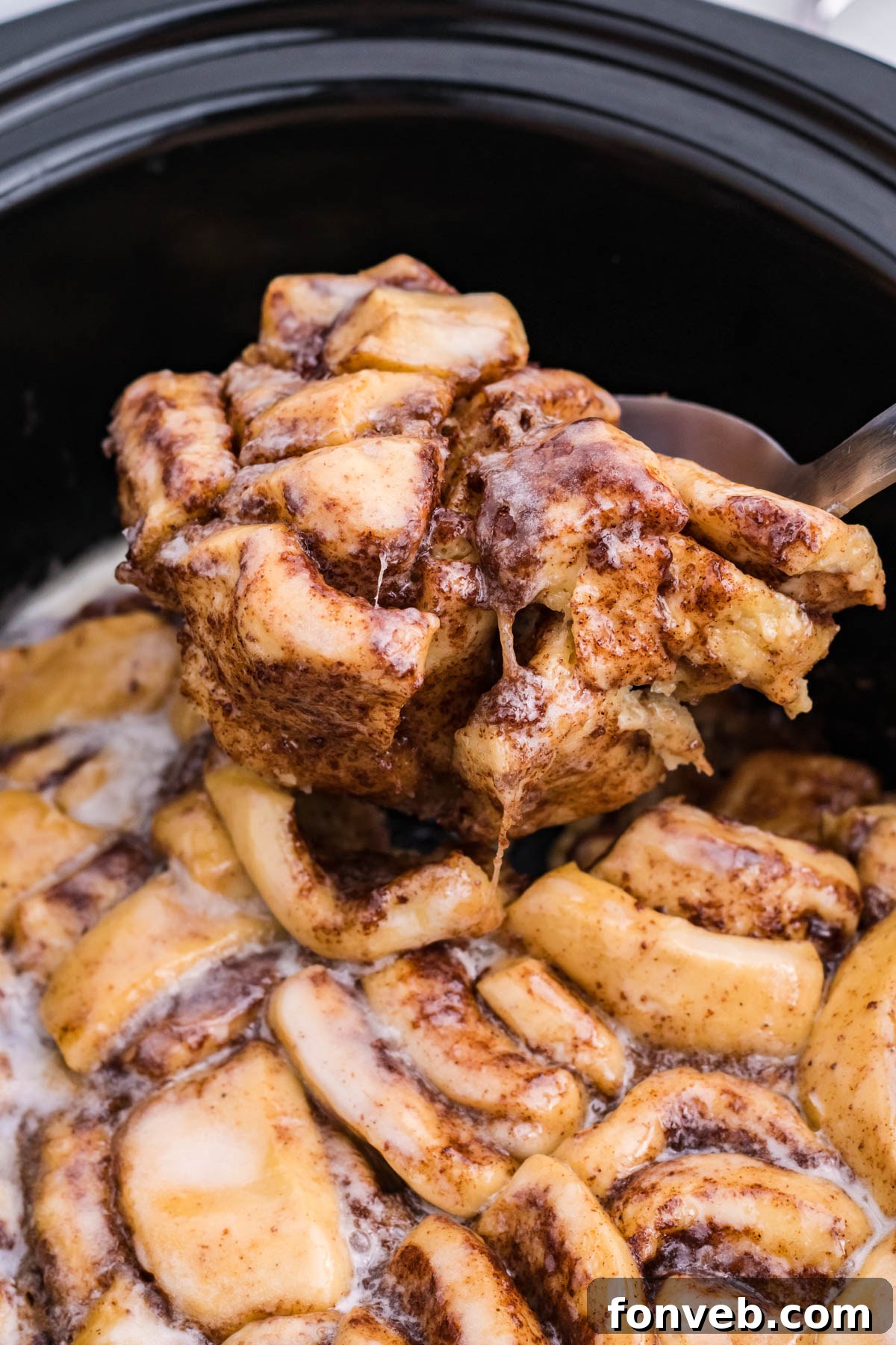 Close up view of the casserole being served using a large silver spoon 