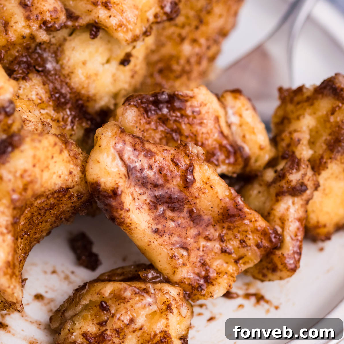 Up close view of the cinnamon sugar on the casserole on a white plate