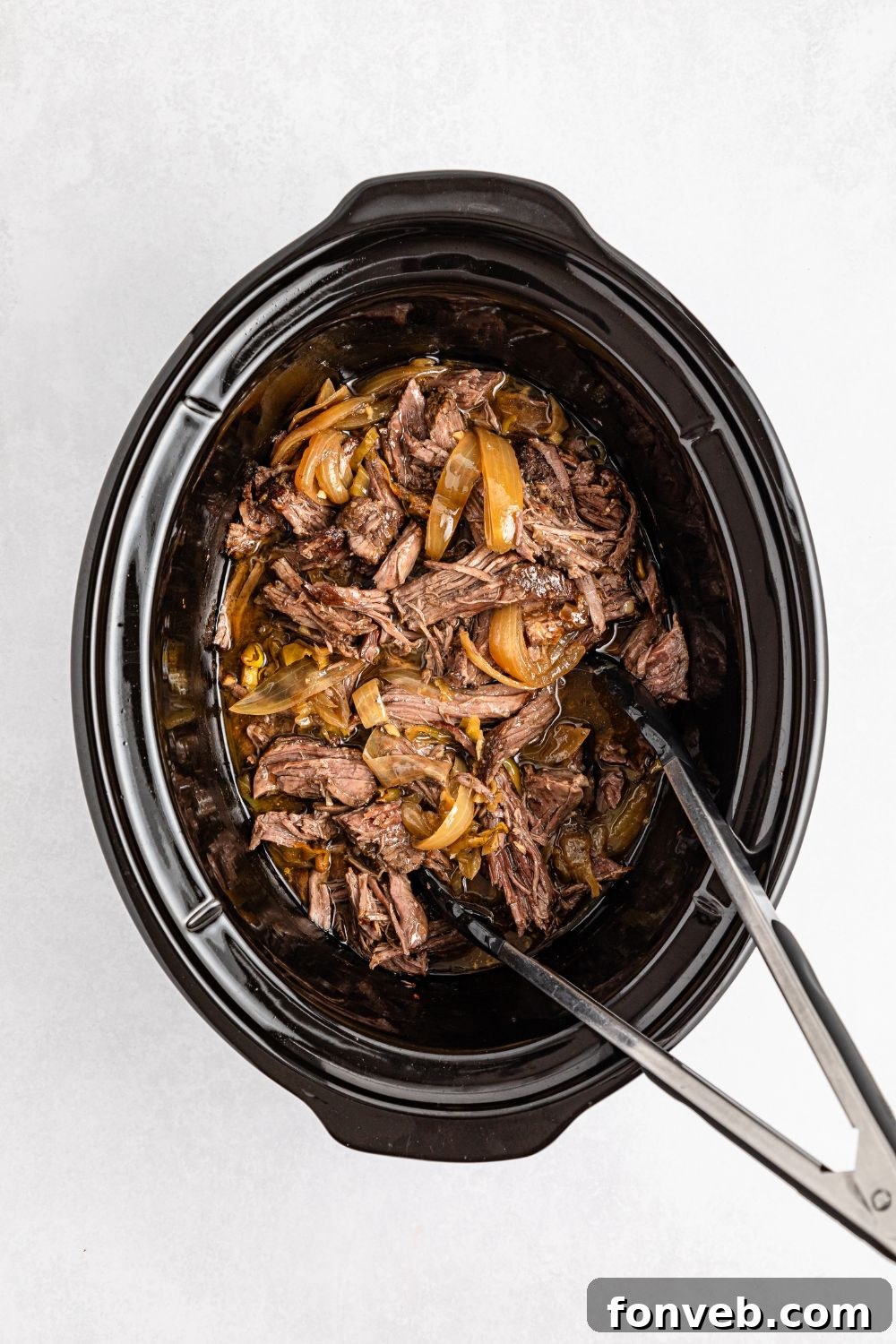 Ultimate Mississippi Pot Roast Sandwiches 14 Slow cooker with Mississippi Pot Roast in it