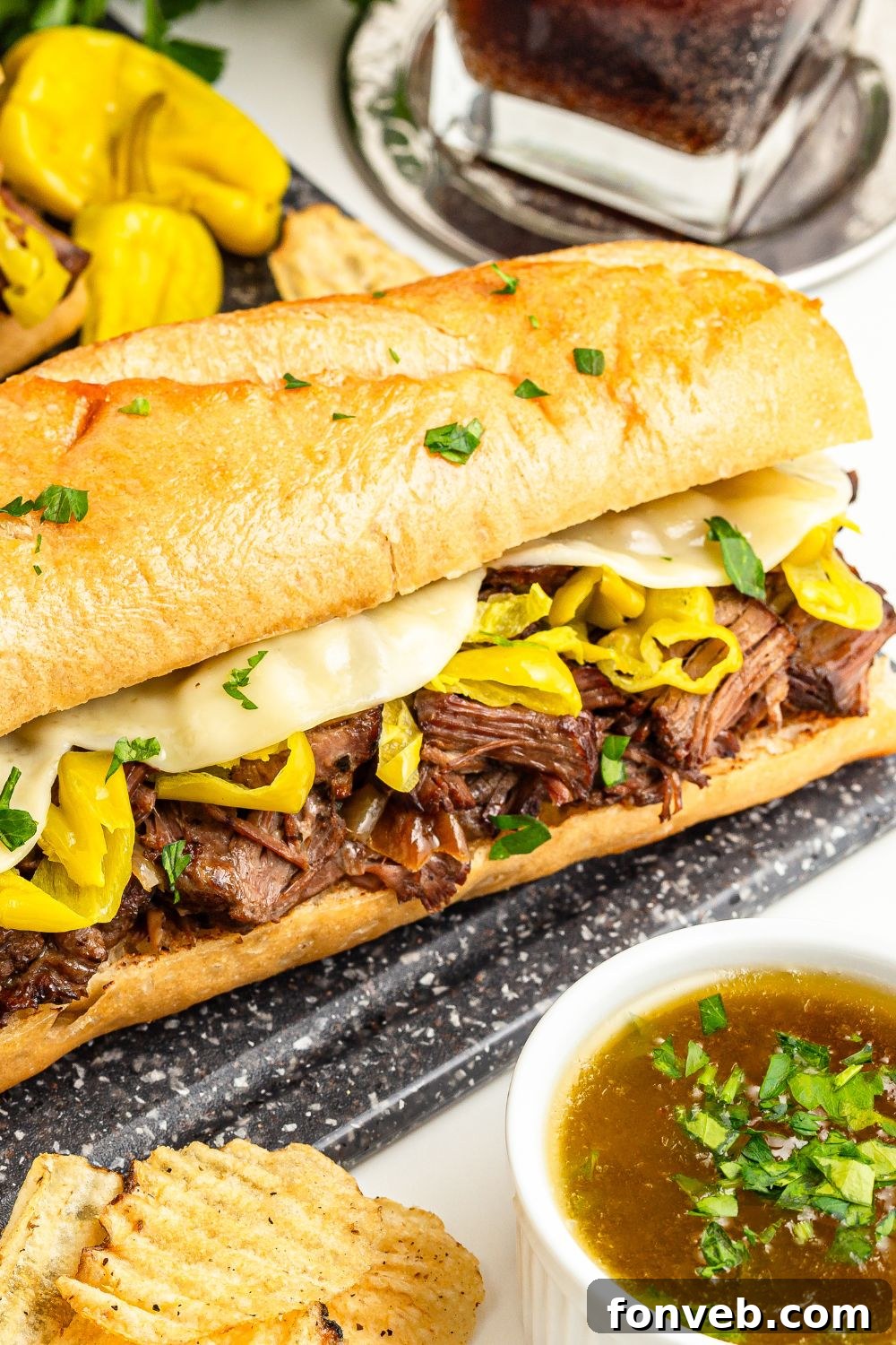 Ultimate Mississippi Pot Roast Sandwiches 17 Mississippi Pot Roast Sandwich on table with sauce in a bowl in front