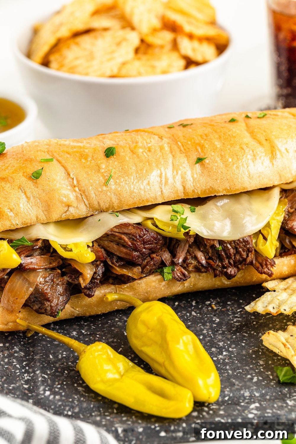 Ultimate Mississippi Pot Roast Sandwiches 7 Mississippi Pot Roast Sandwich on table with peppers in front of it