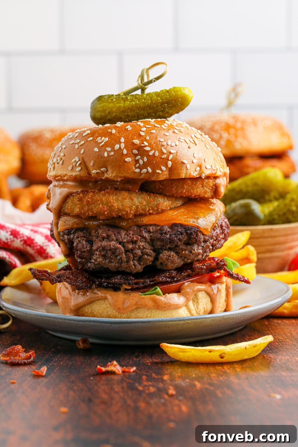 Chuck Wagon Burger 13 Multiple plates, each with a fully assembled Cowboy Burger and a small serving of fries in front, ready to be served.