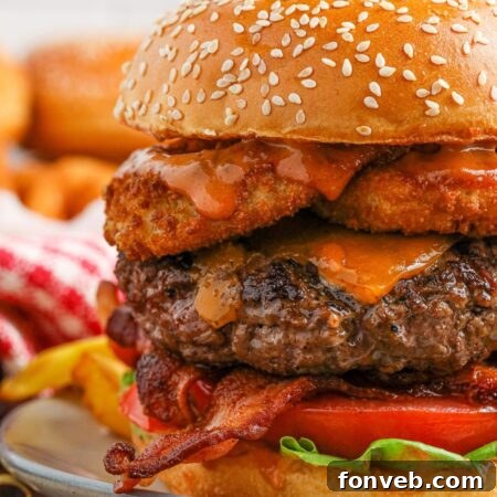Chuck Wagon Burger 19 Close up view of a cowboy burger on a plate with a pickle on top
