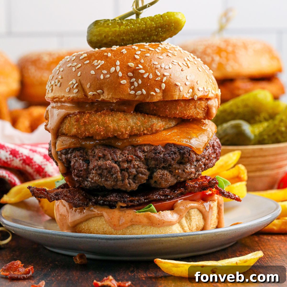 Chuck Wagon Burger 3 An overhead view of a perfectly assembled Cowboy Burger, showcasing all its delicious layers of meat, cheese, bacon, and onion rings.