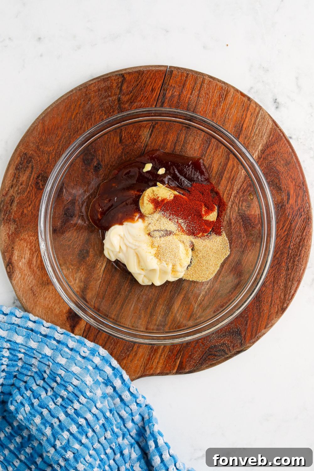 Chuck Wagon Burger 10 Individual ingredients for the Cowboy Burger sauce, including mayo, BBQ sauce, Dijon, paprika, and garlic powder, in small glass bowls.