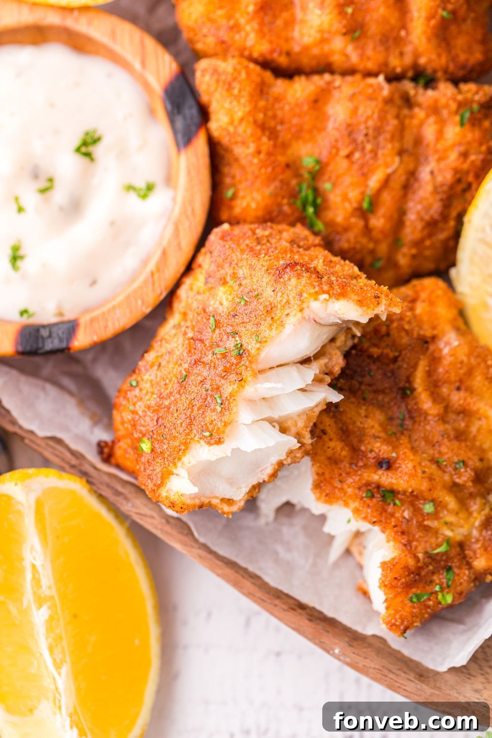 Crispy Air-Fried Fish and Chips 14 Air Fryer Fish And Chips on platter with tartar sauce in a small bowl