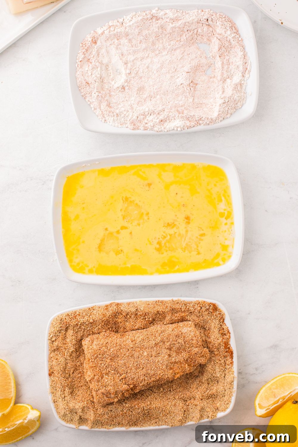 Crispy Air-Fried Fish and Chips 10 dredging fish in breadcrumbs in a bowl