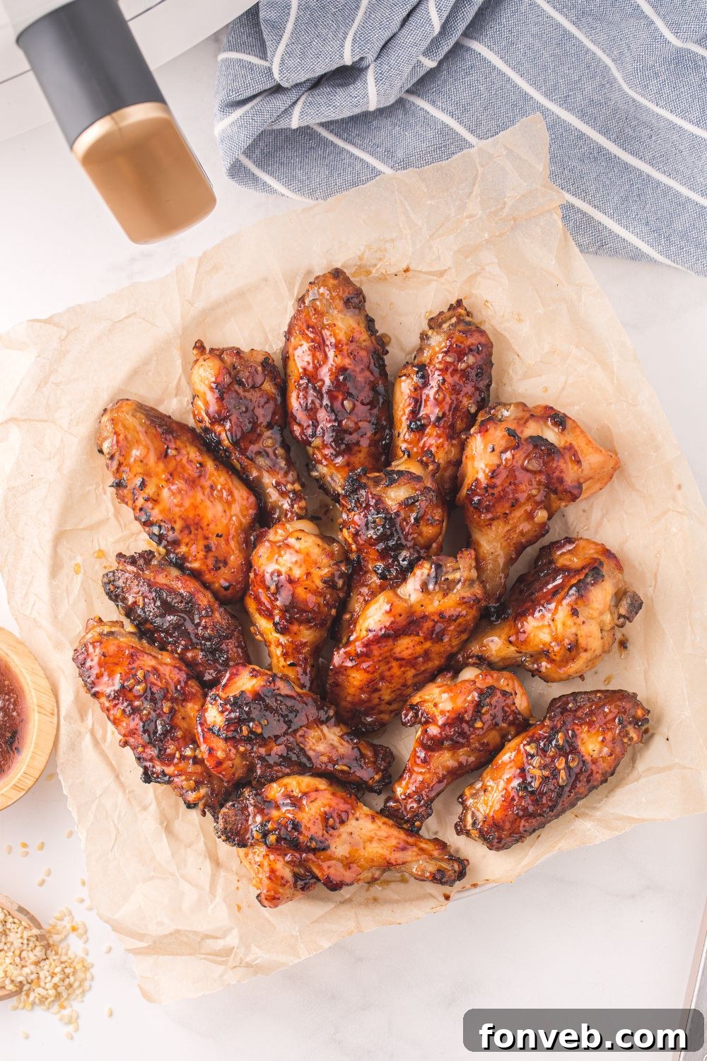 Air Fryer Honey Chicken Wings on a parchment lined plate 