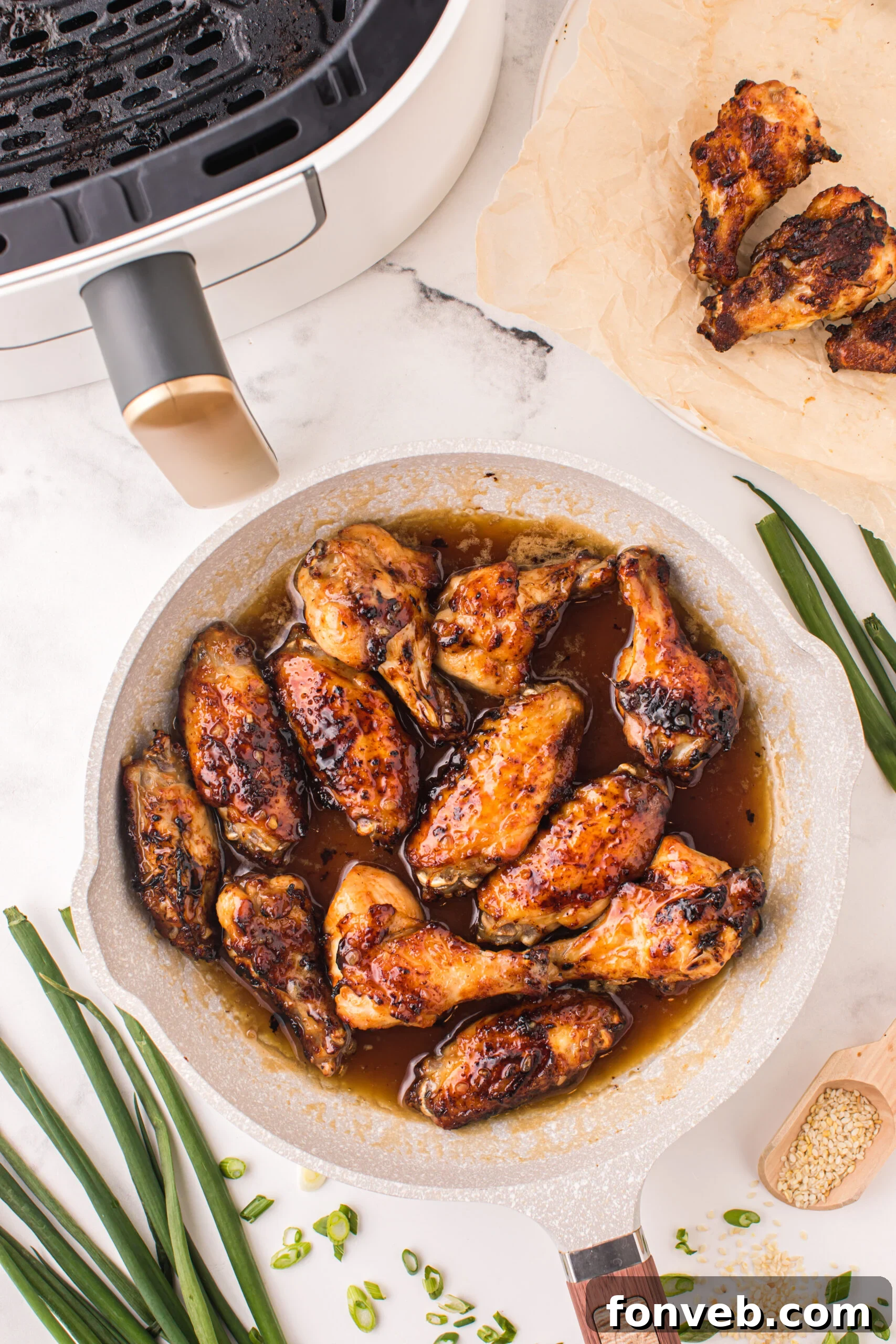 Skillet with the Air Fryer Honey Garlic Chicken Wings inside 
