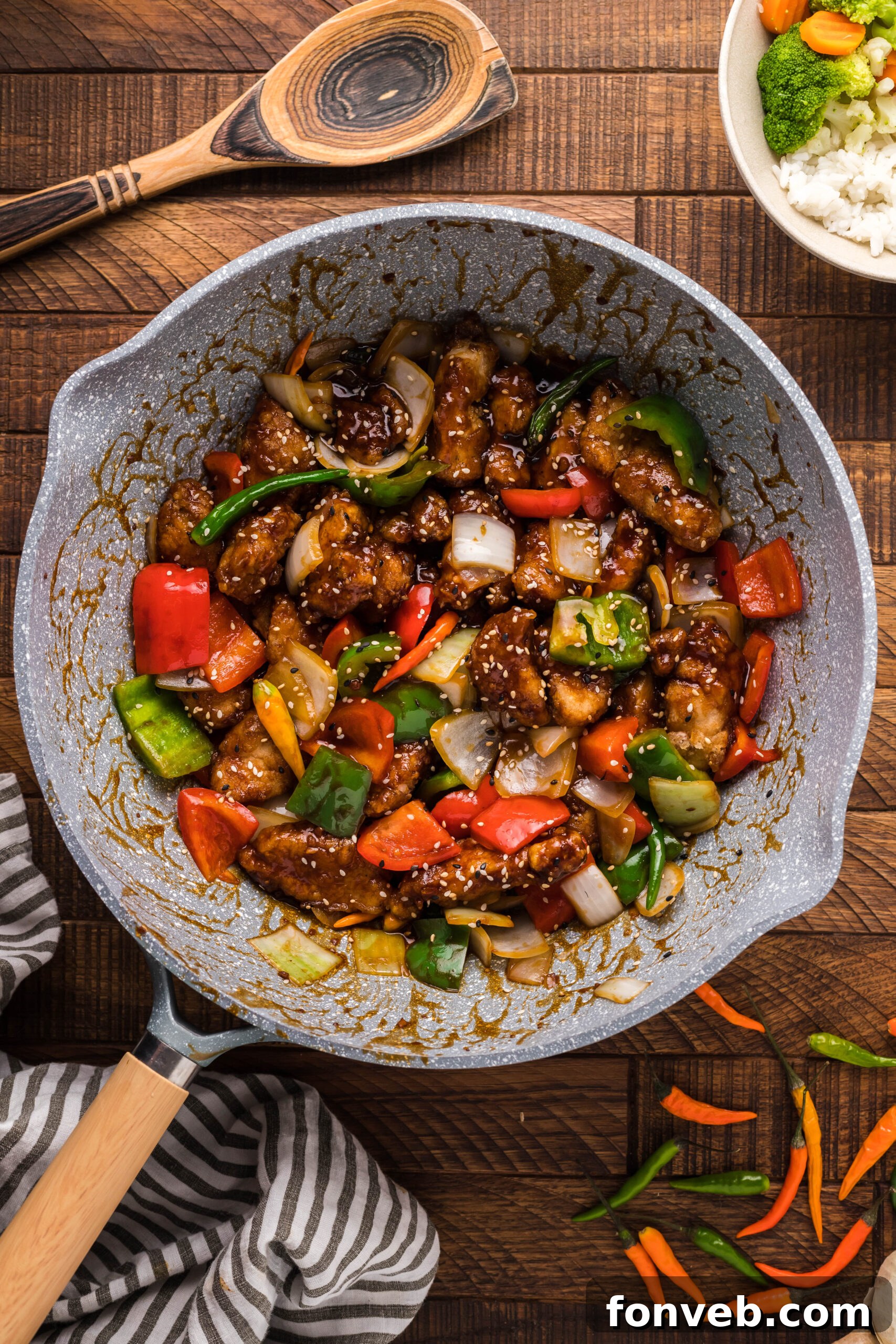 An overhead shot of the glistening General Tso Chicken generously coated in sauce, served in a stylish white skillet.