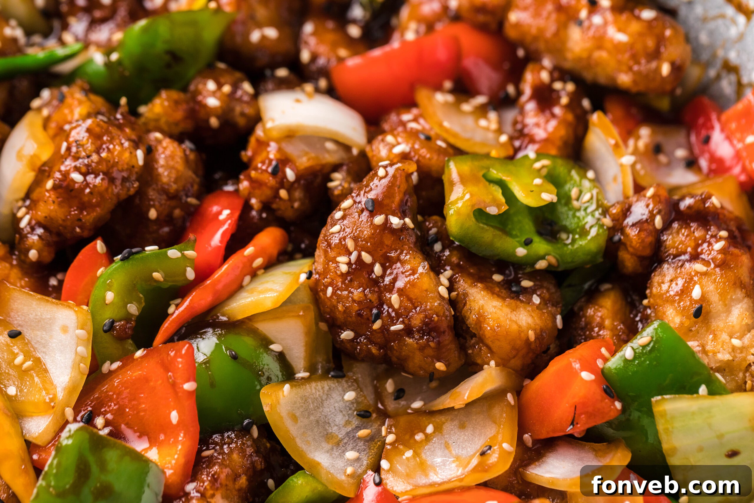 A very up-close shot of the tender, saucy General Tso Chicken, showcasing its rich texture and coating.