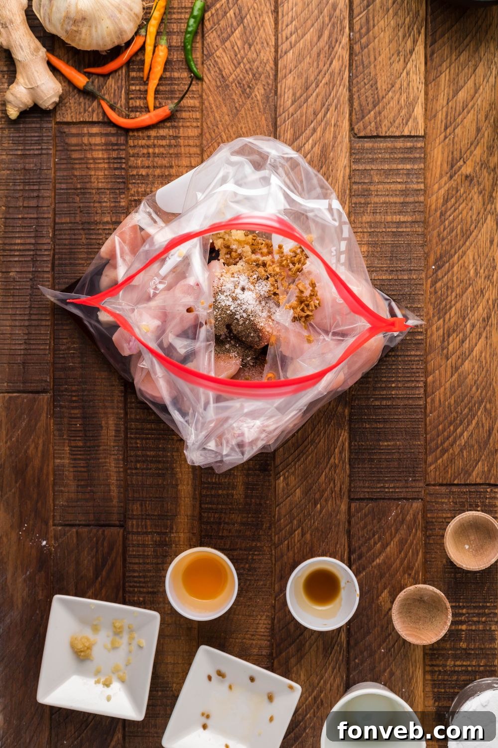 Chicken pieces coated in cornstarch, sealed in a Ziplock bag, ready for frying.