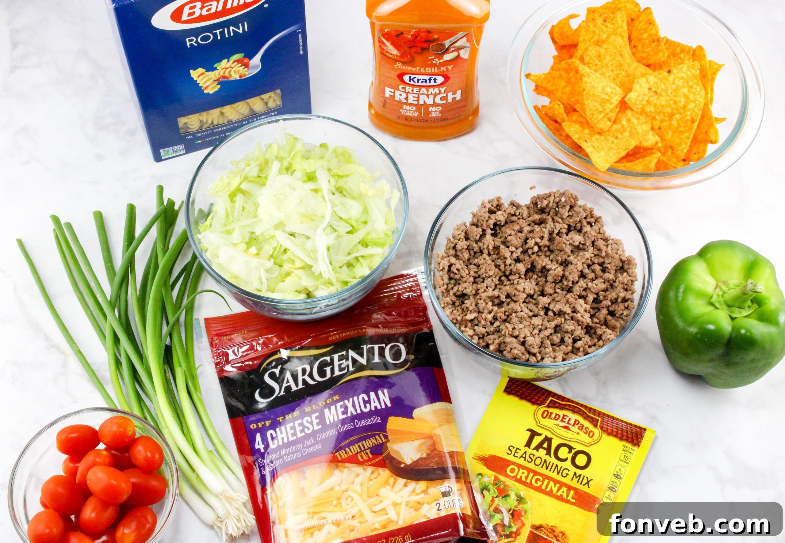 Overhead view of a prepared Doritos Taco Pasta Salad in a glass bowl, showcasing the colorful ingredients.