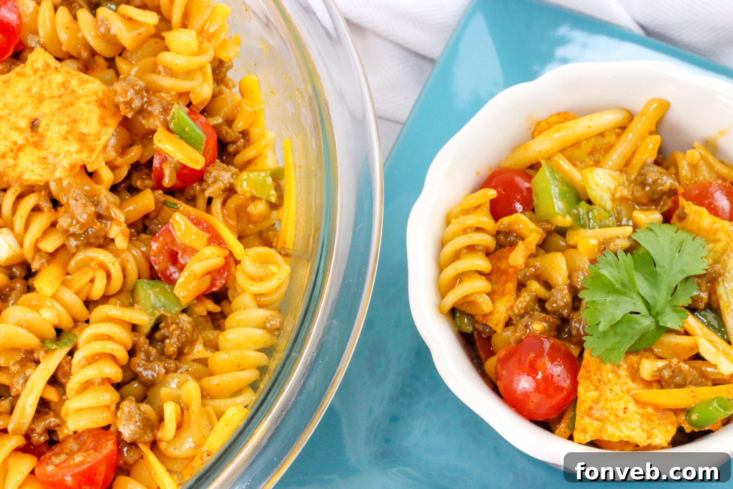 Close up of a spoon scooping a generous portion of Doritos Taco Pasta Salad.