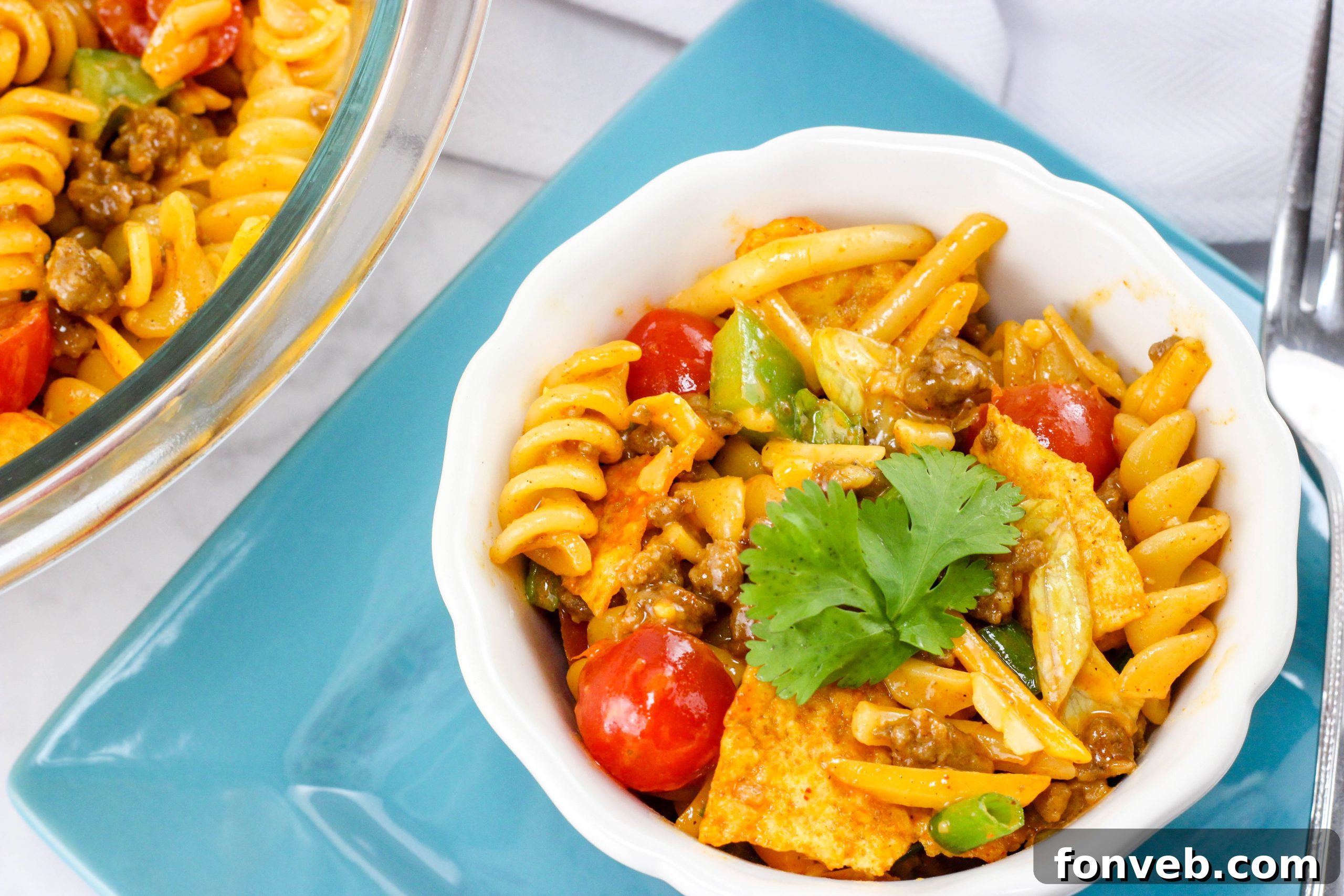 Side view of the Doritos Taco Pasta Salad with a serving spoon, highlighting the various textures.