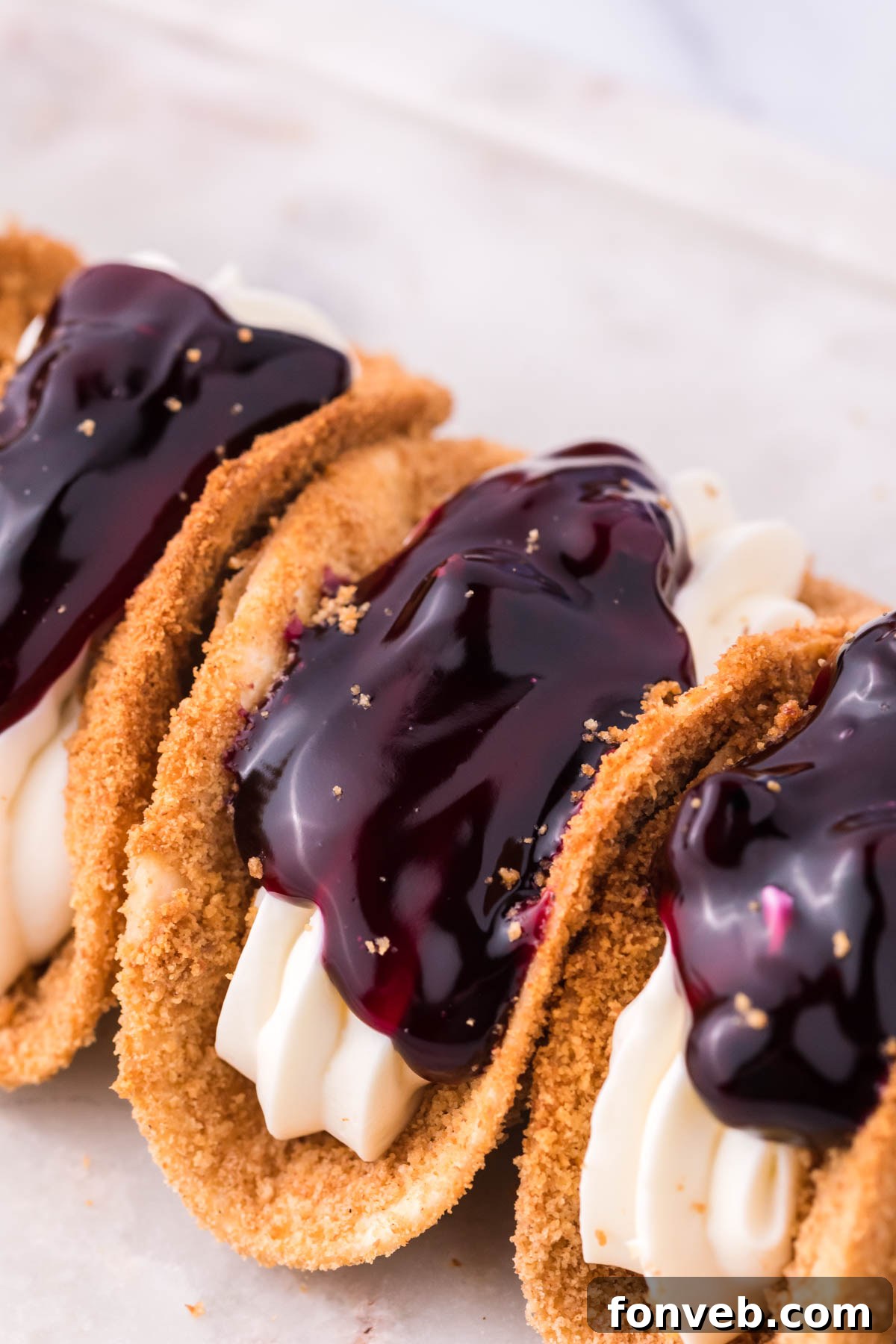 Blueberry Cheesecake Taco Twist 2 Close up of the filling and topping of blueberry cheesecake tacos.