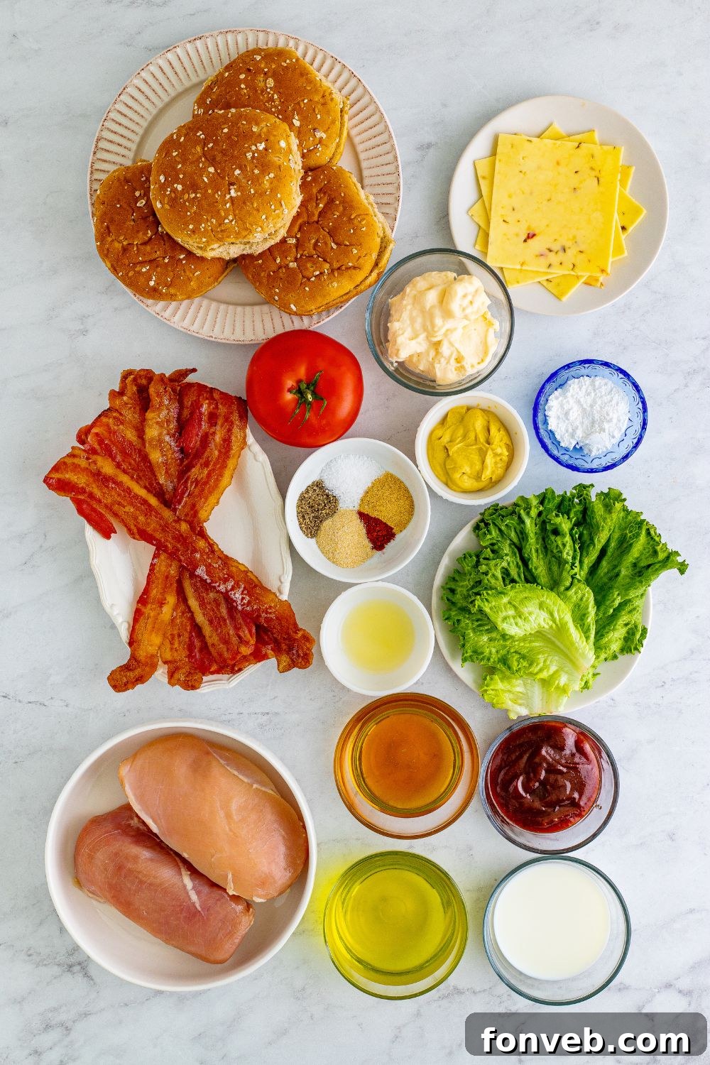 Fresh ingredients for homemade Chick-fil-A Grilled Chicken Sandwiches, neatly arranged in small bowls on a table.