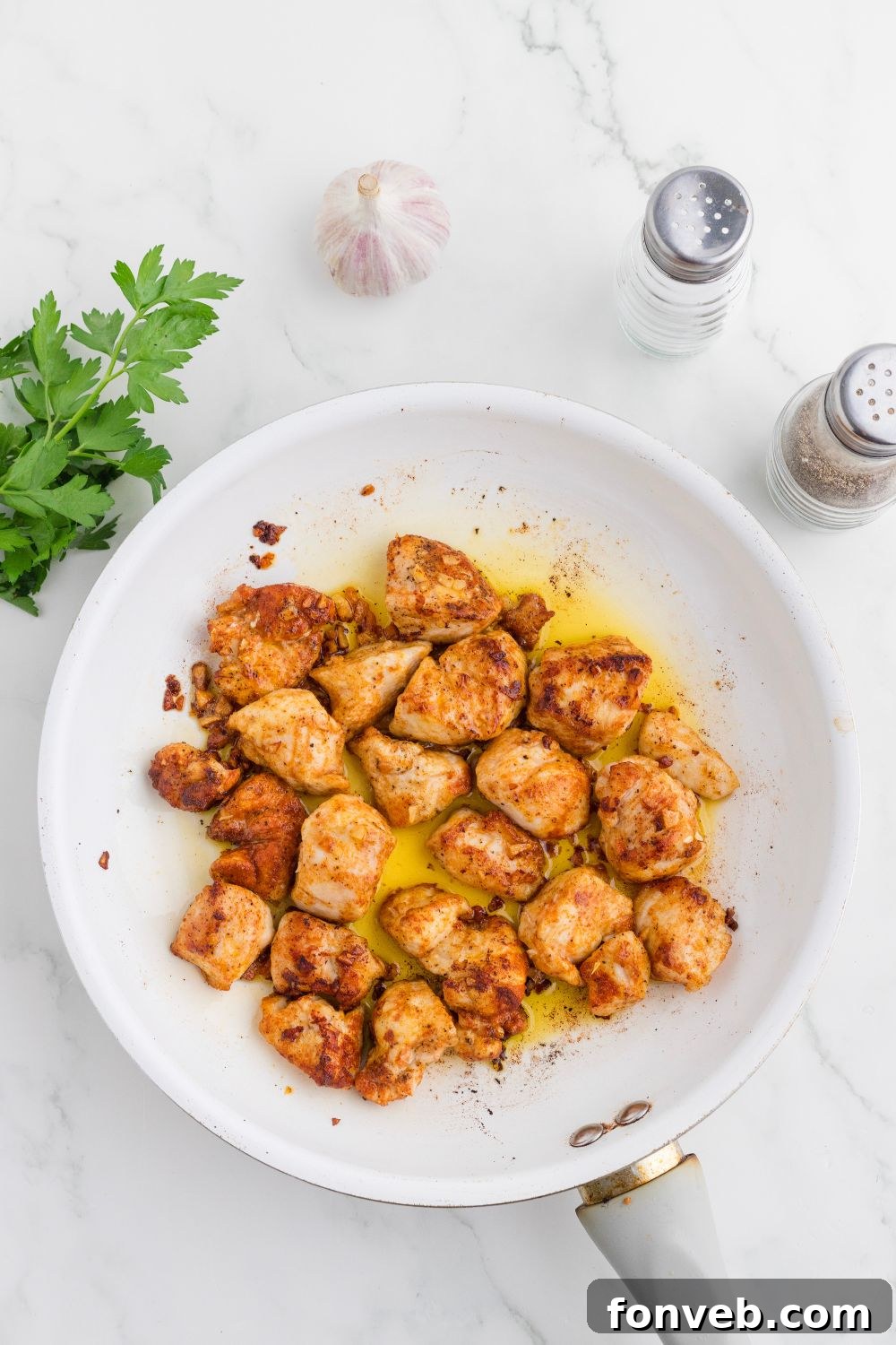 skillet with cooked Garlic Butter Chicken Bites in it