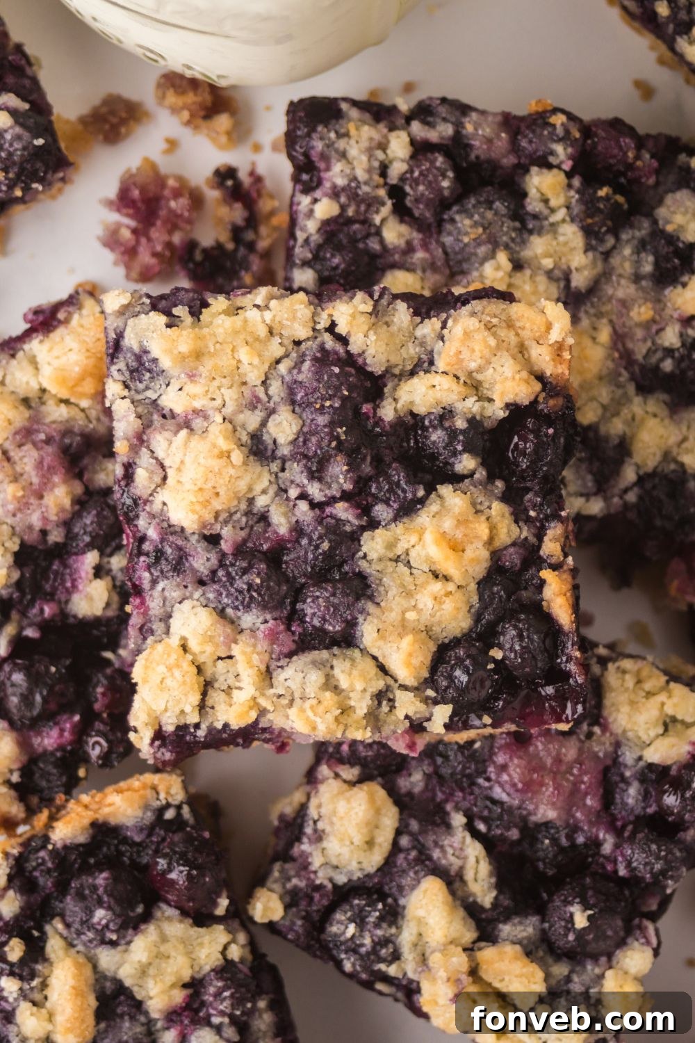 Blueberry Crumb Bars stacked on top of one another 