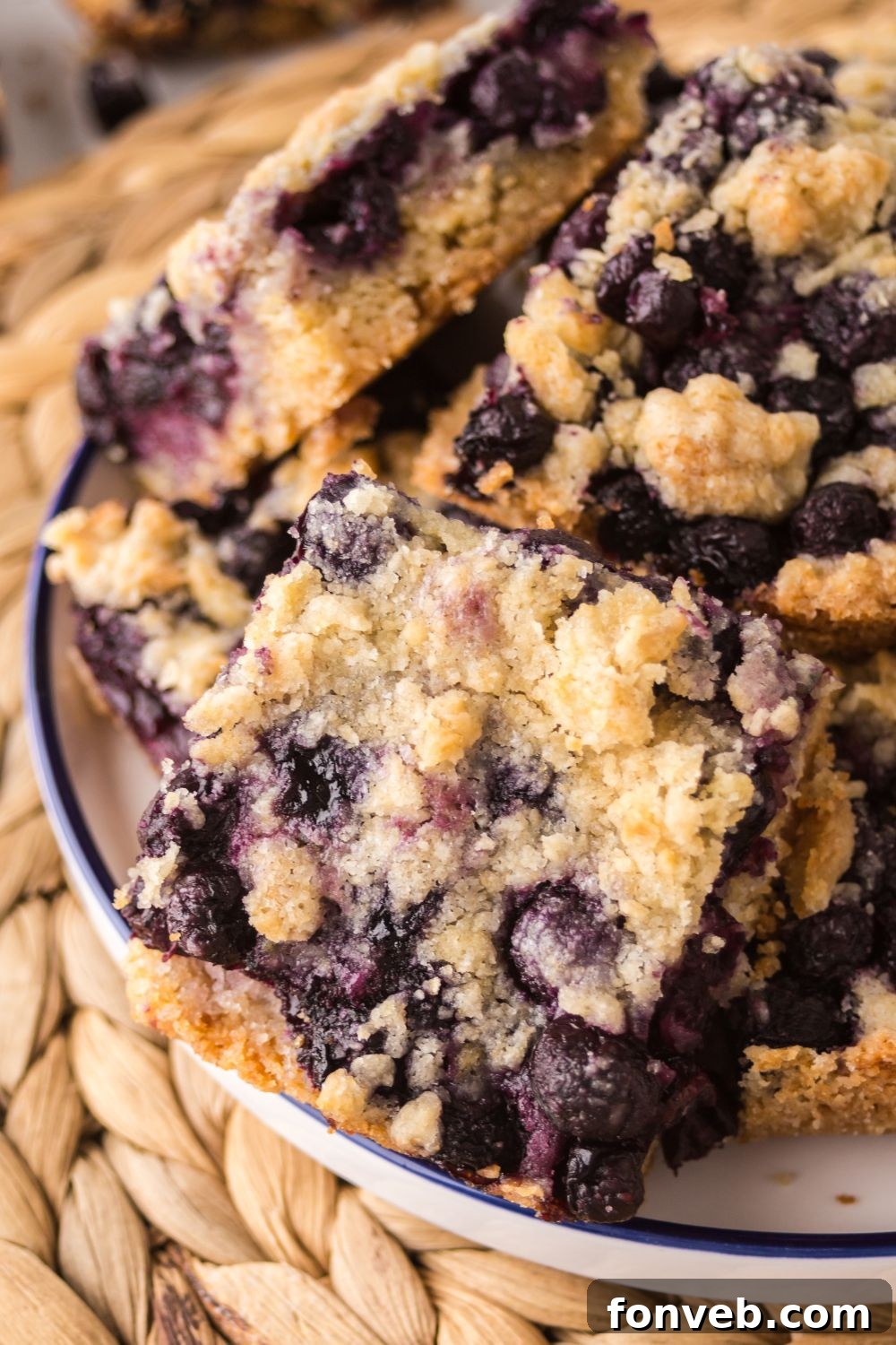 Blueberry Crumb Bars in a bowl that are sliced in squares 