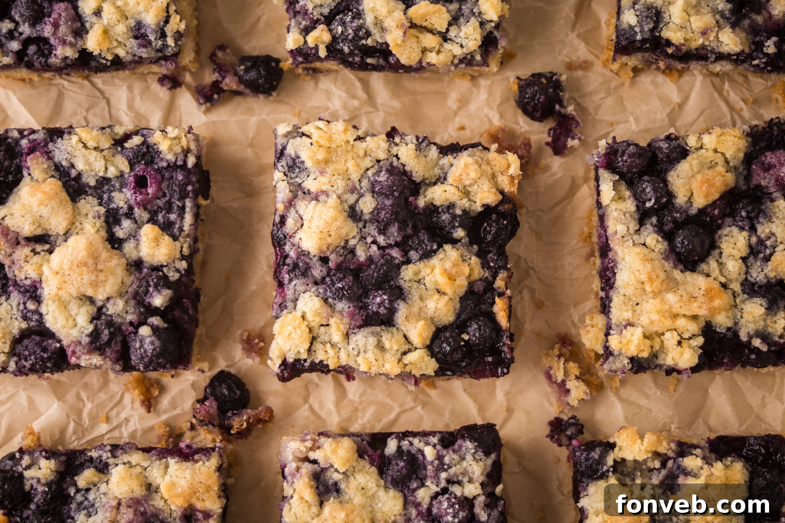 blueberry crumble bars on table all neatly cut into squares