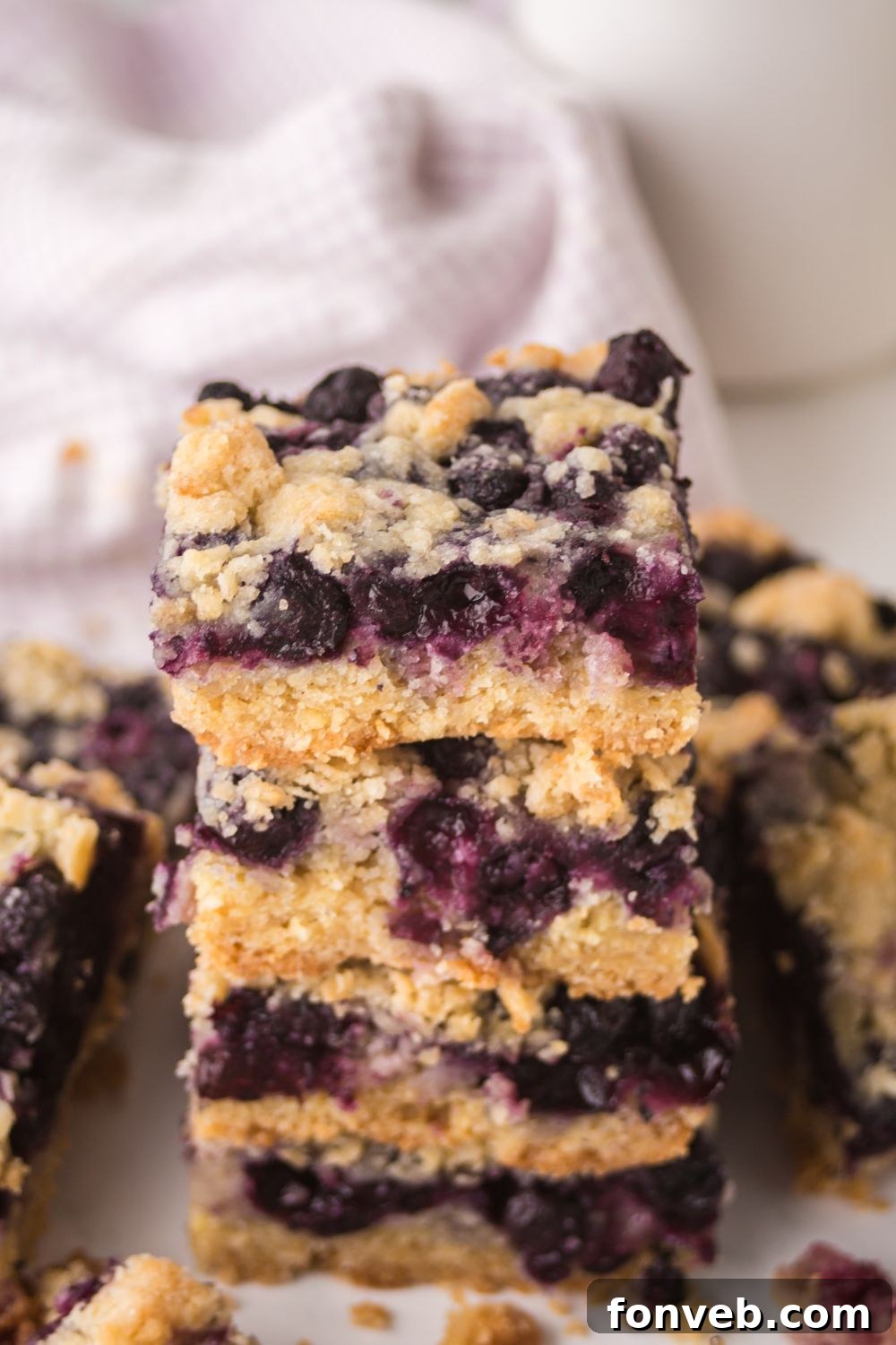 summer Blueberry Crumb Bars stacked on table 
