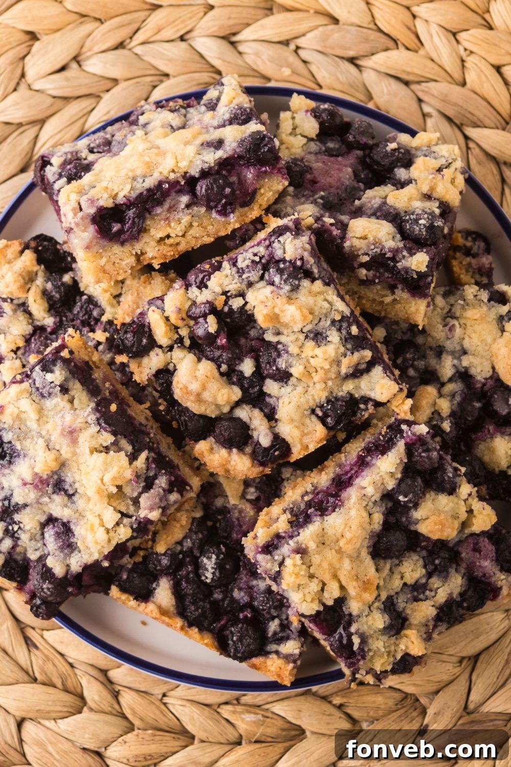 Blueberry Crumb Bars on a plate stacked on top of one another 