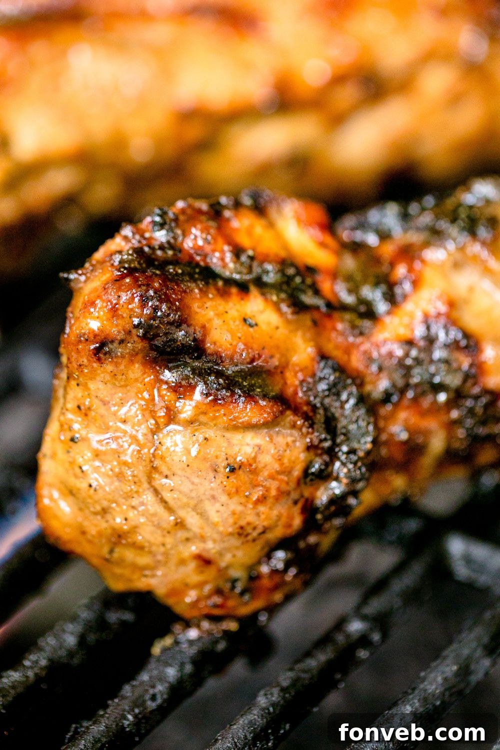 grilled pork on a grill being cooked 