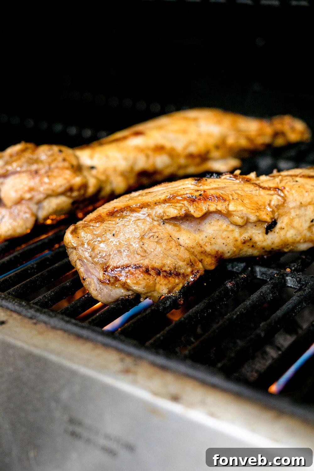 Grilled Pork Tenderloin on a grill being cooked