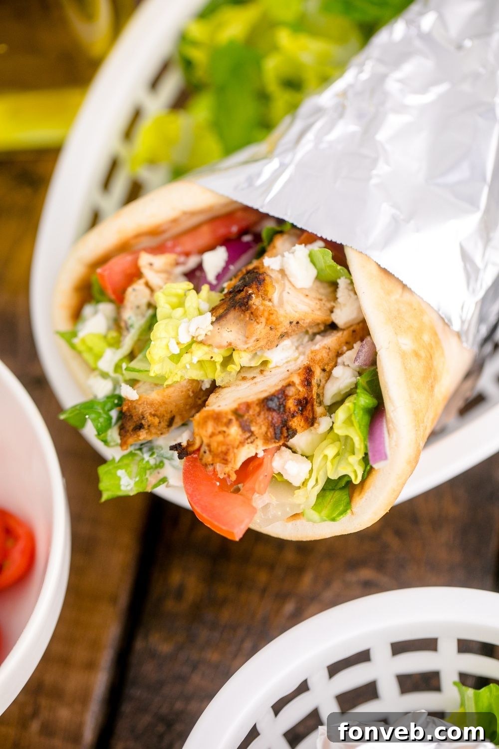 close up look of a chicken gyro wrap in a food basket
