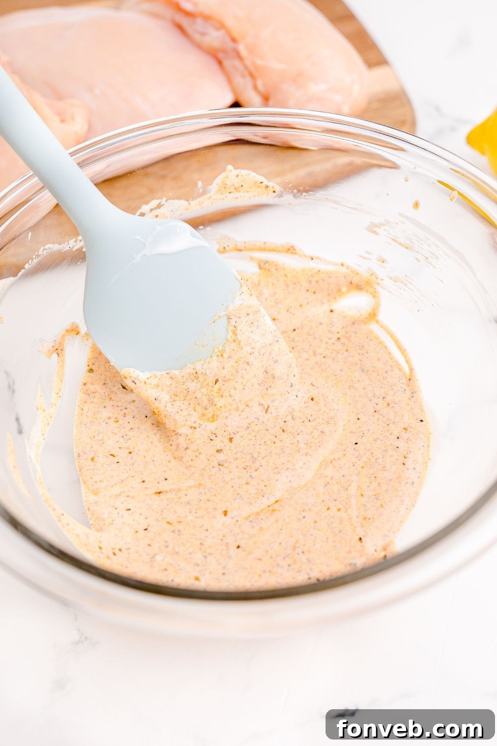 sauce in a bowl with spatula in it on table