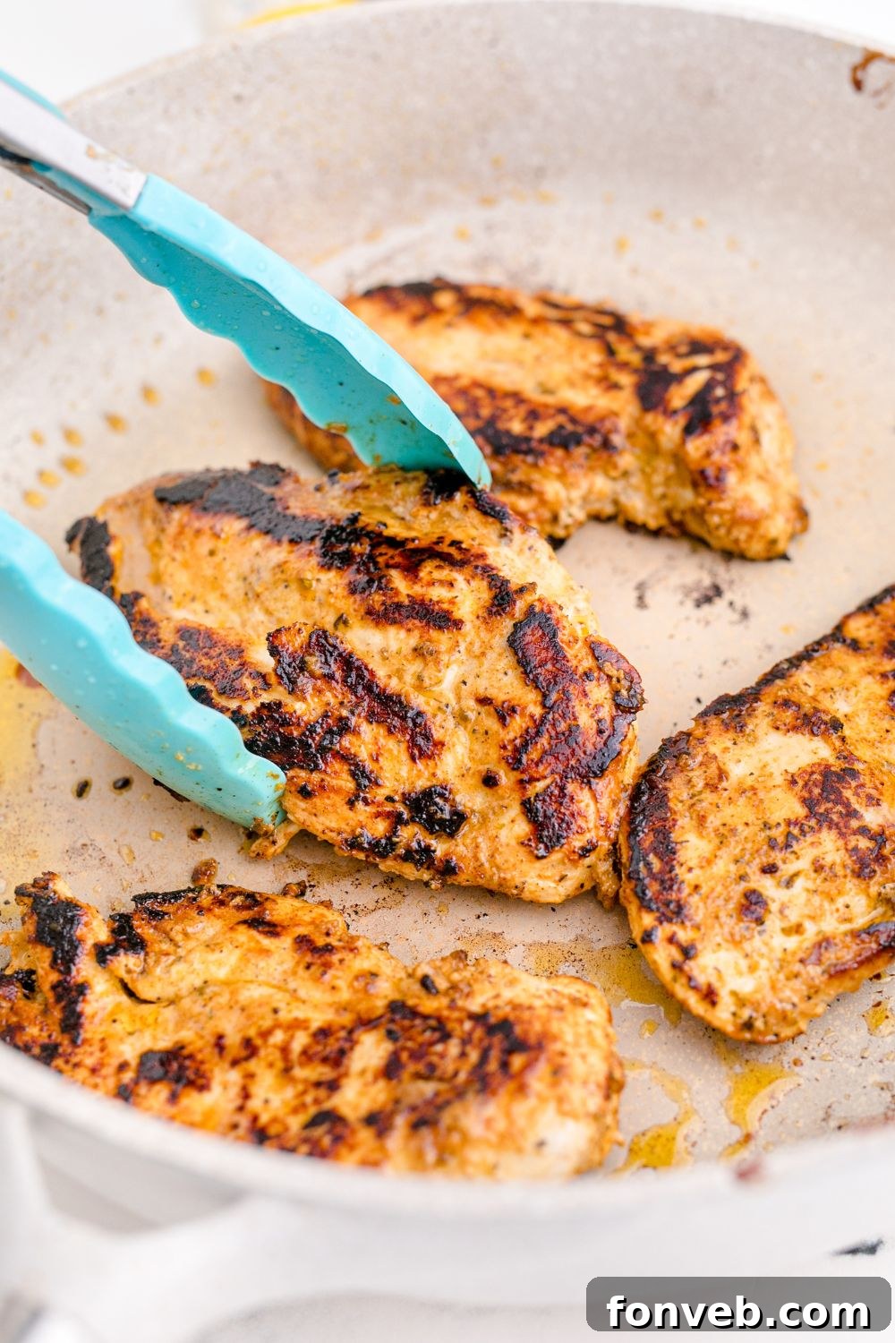 chicken being cooked in skillet