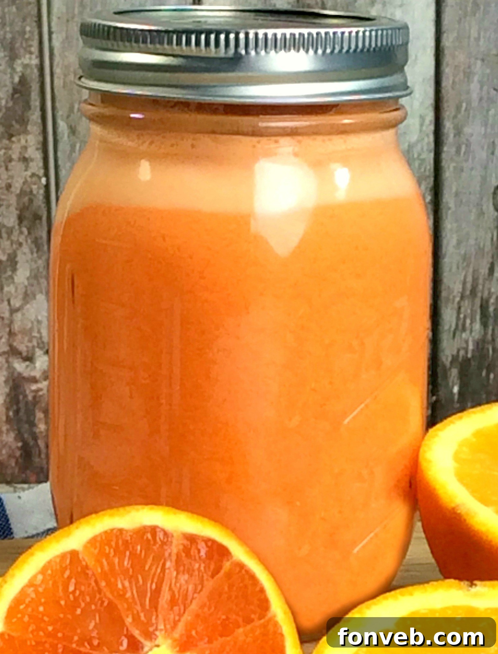 A mason jar filled with a colorful beverage, potentially Skittles Moonshine, with candy garnishes.