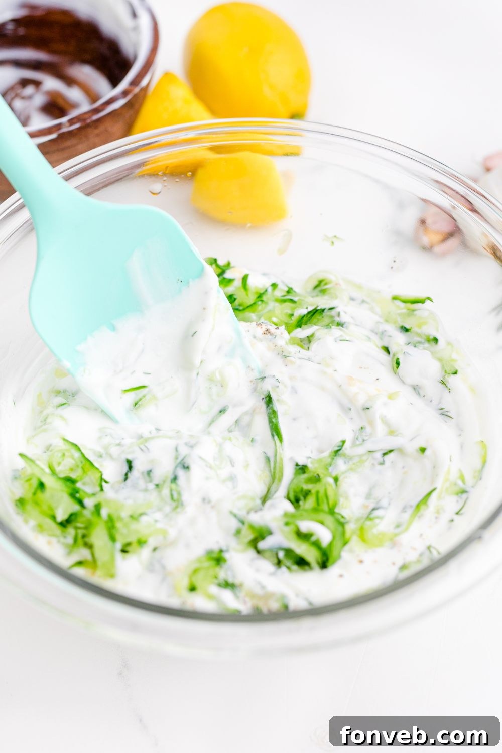 mixing up Tzatziki Sauce in a bowl