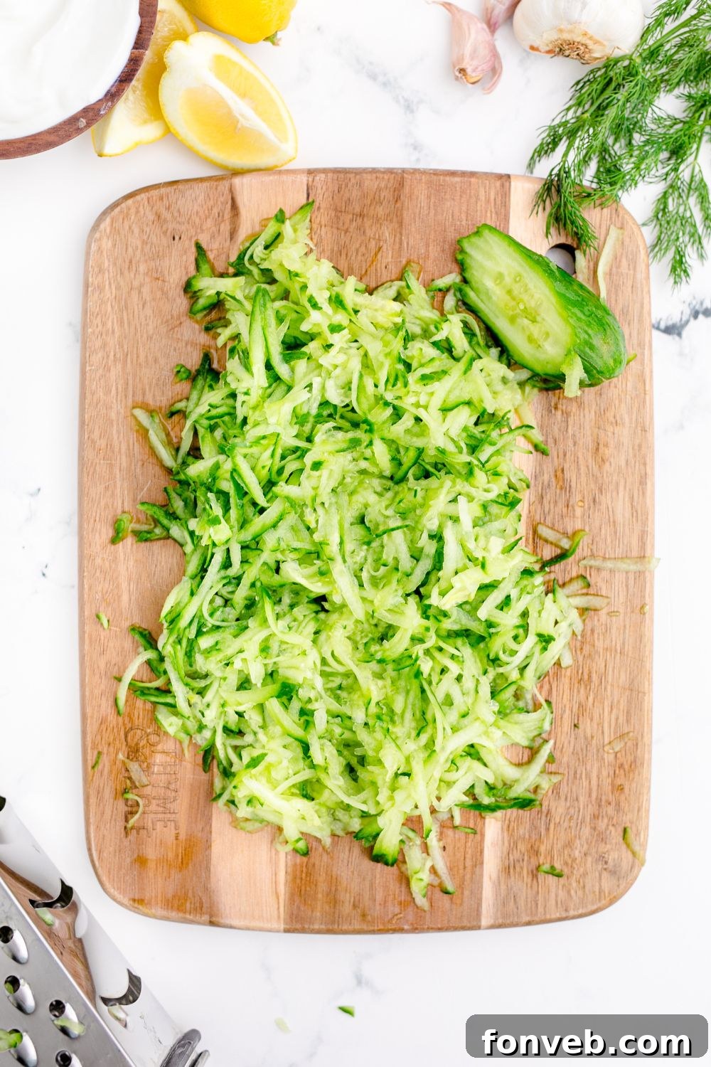 shredded cucumbers on a cutting board