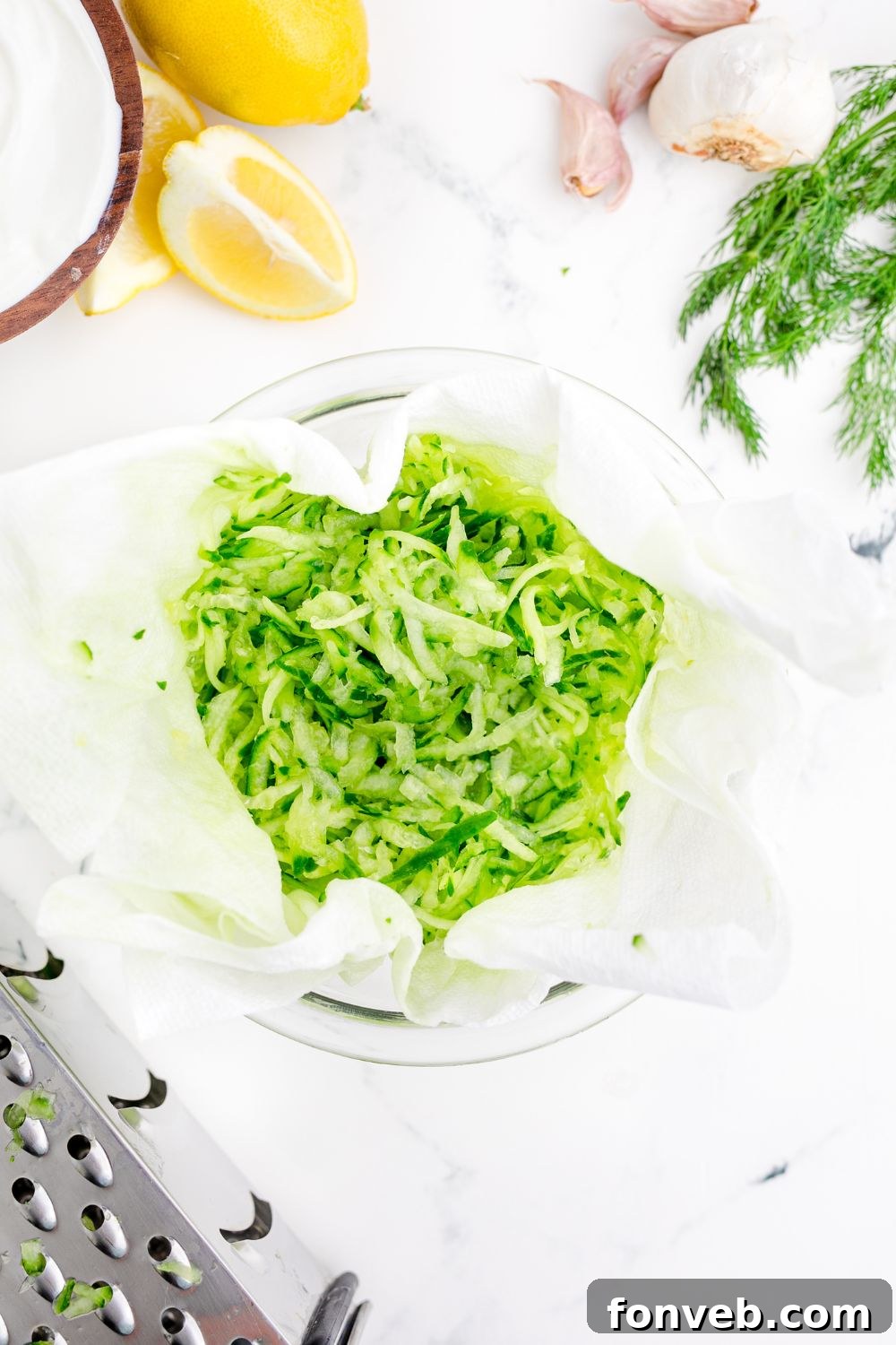 shredded cucumbers in a cheesecloth on table