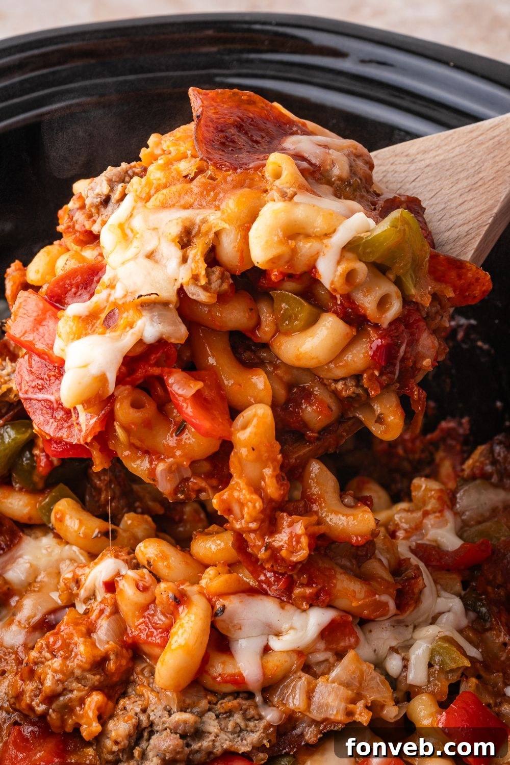 scoop of pizza casserole in slow cooker