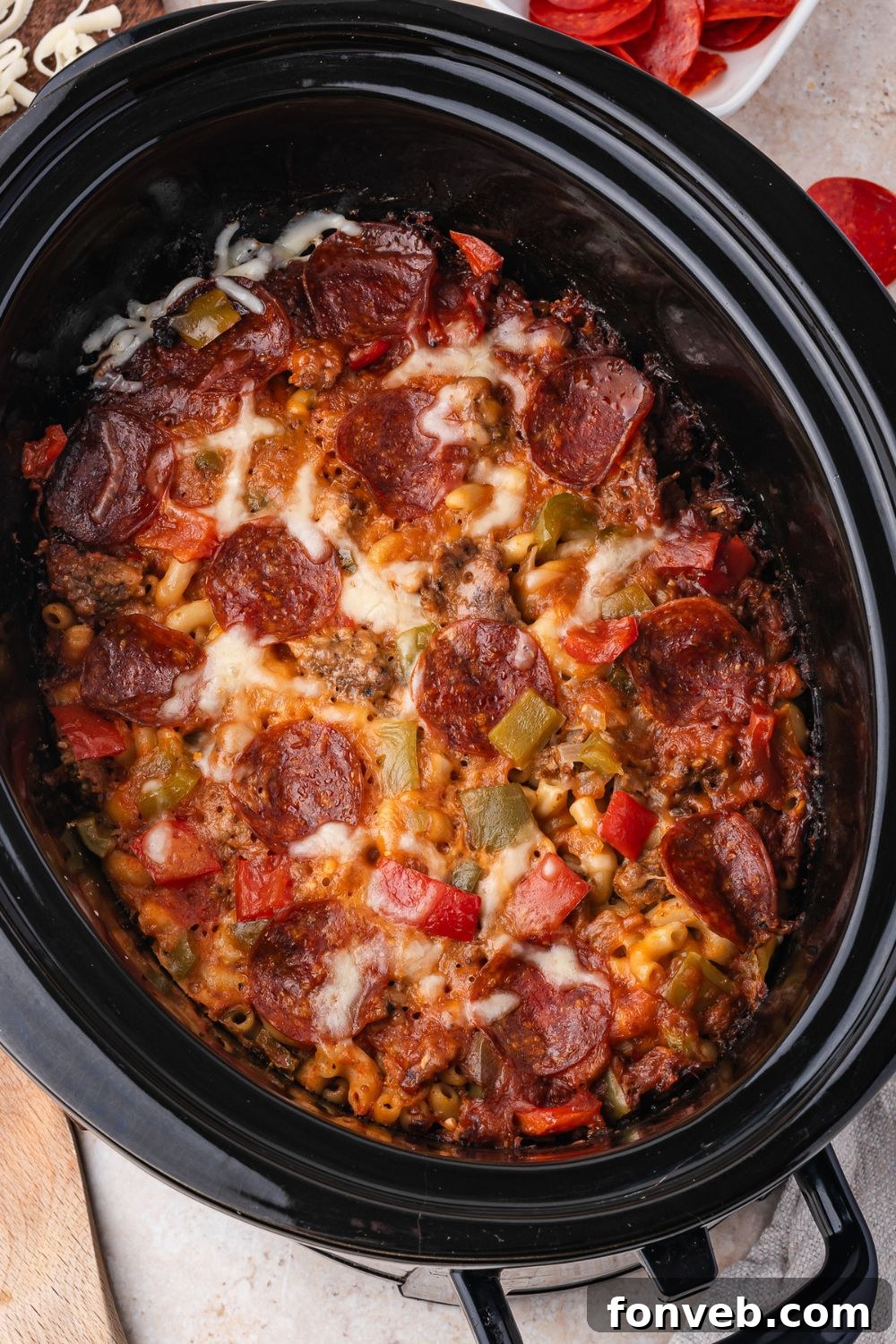 slow cooker on table with meaty pasta inside