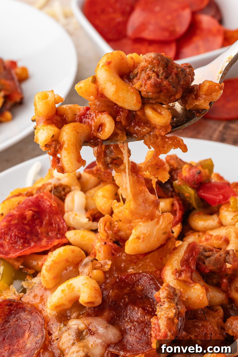 pizza casserole being scooped up with a fork off plate