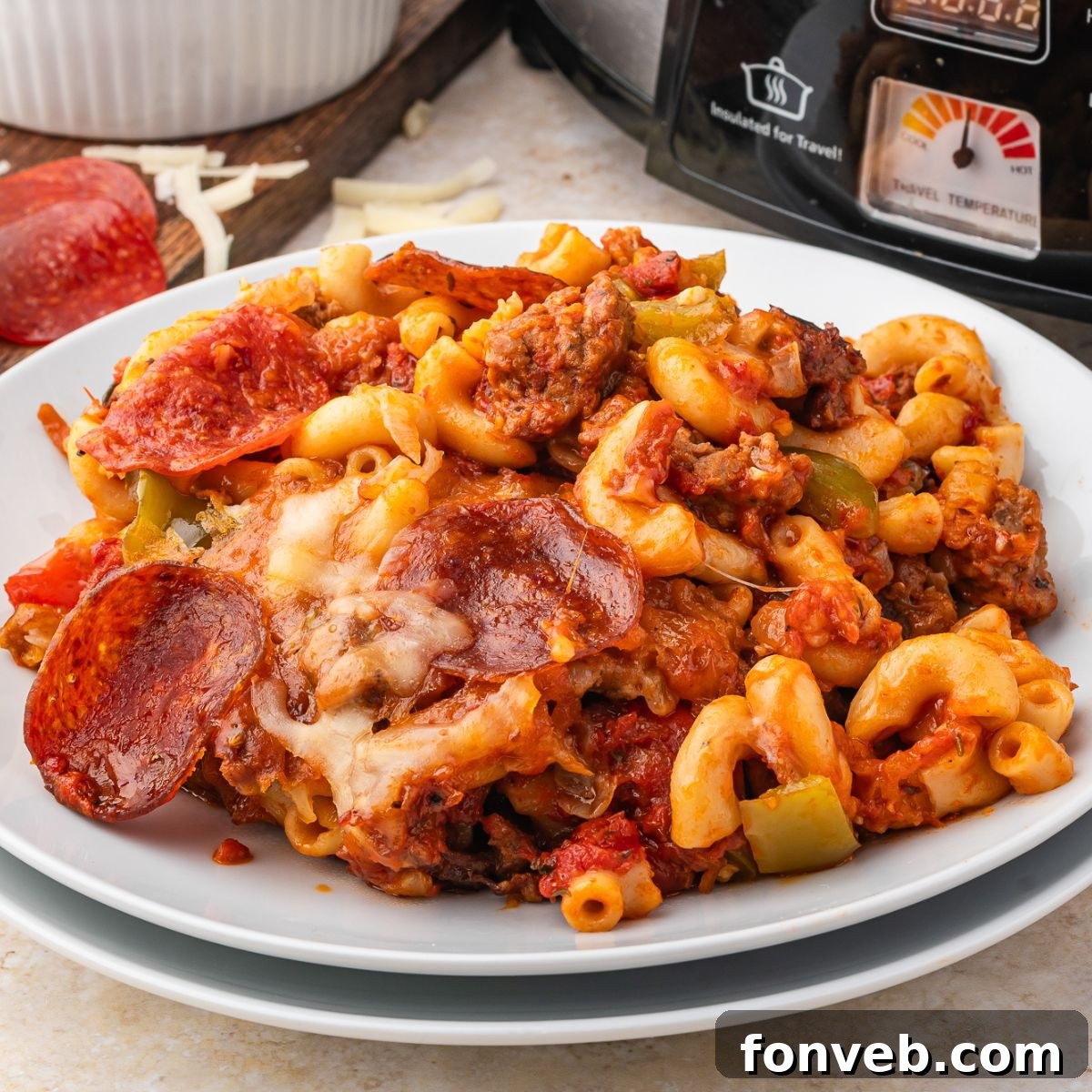 Pizza Casserole on a plate with slow cooker behind it