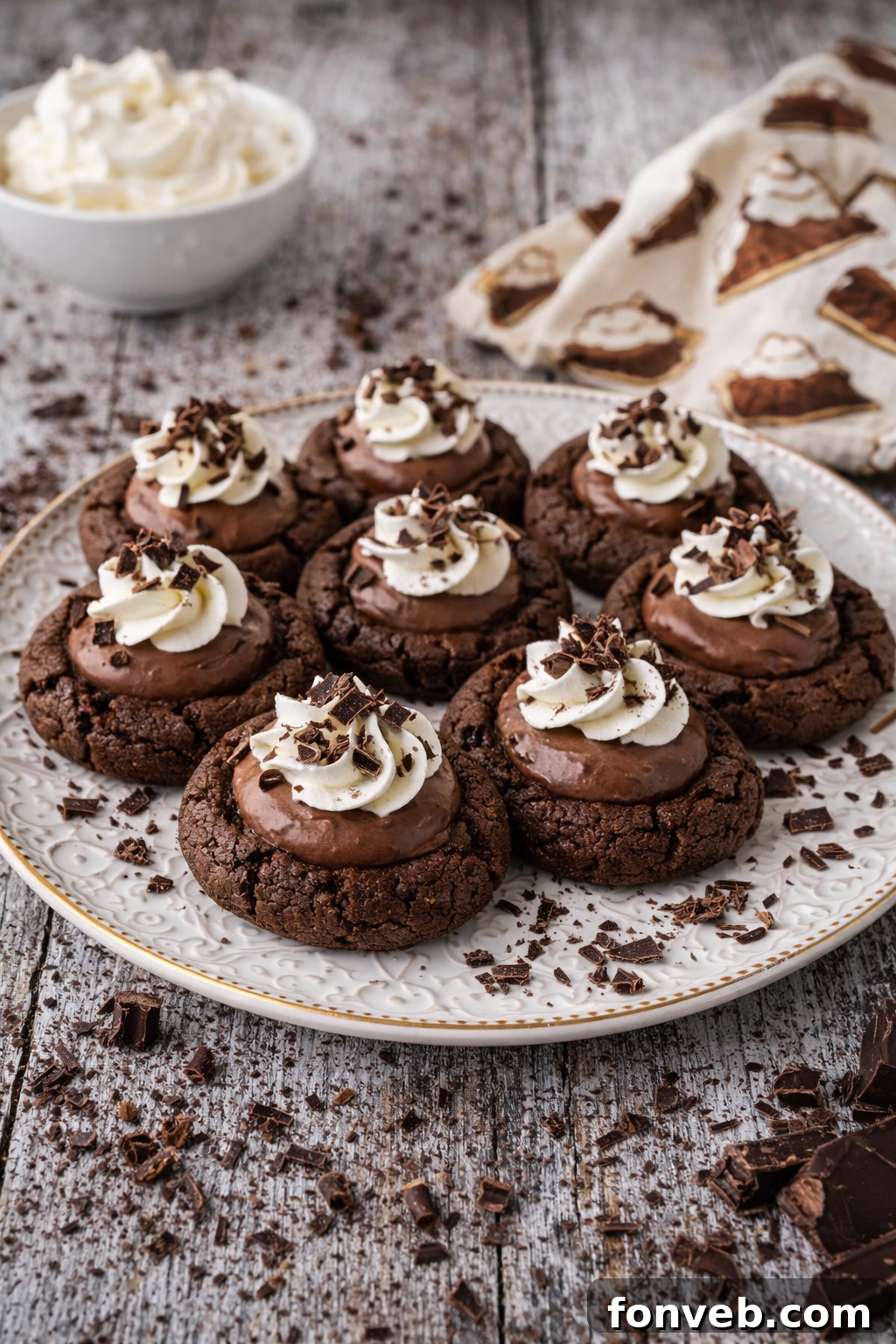 Chocolate Pie Cookies arranged artfully on a pristine white plate, set against a warm, inviting wooden table background.