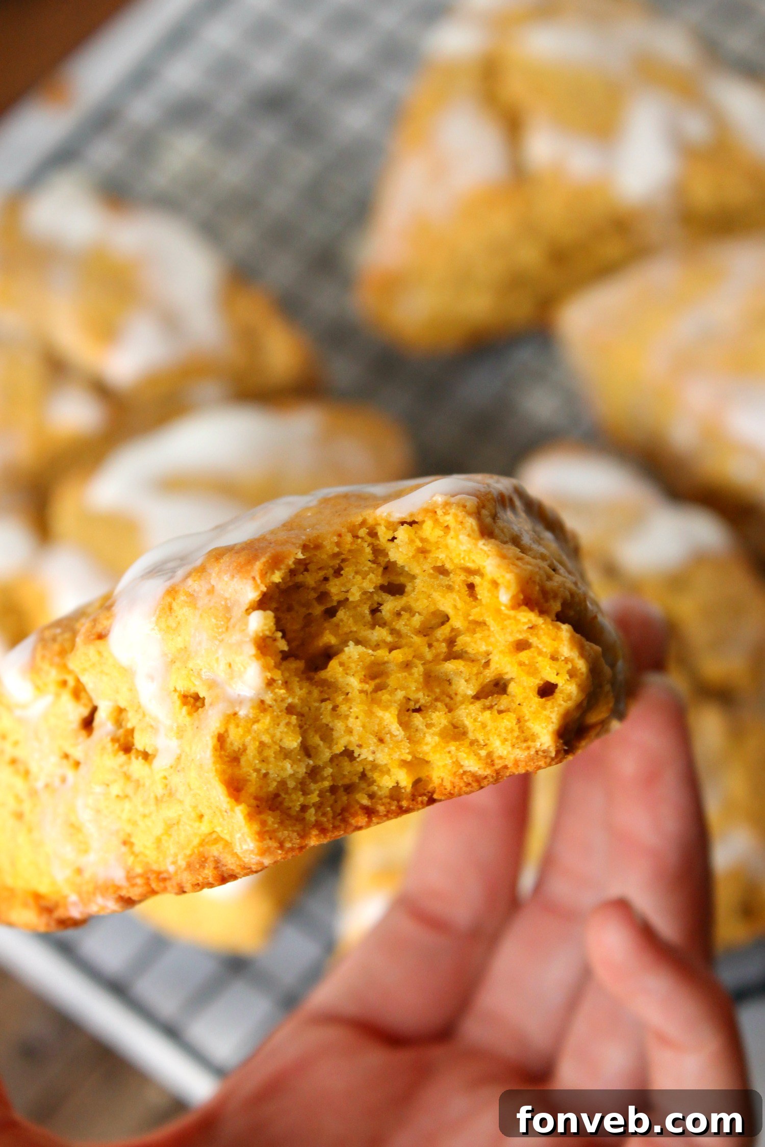Freshly baked pumpkin pie glazed scones cooling on a rack, ready to be glazed.
