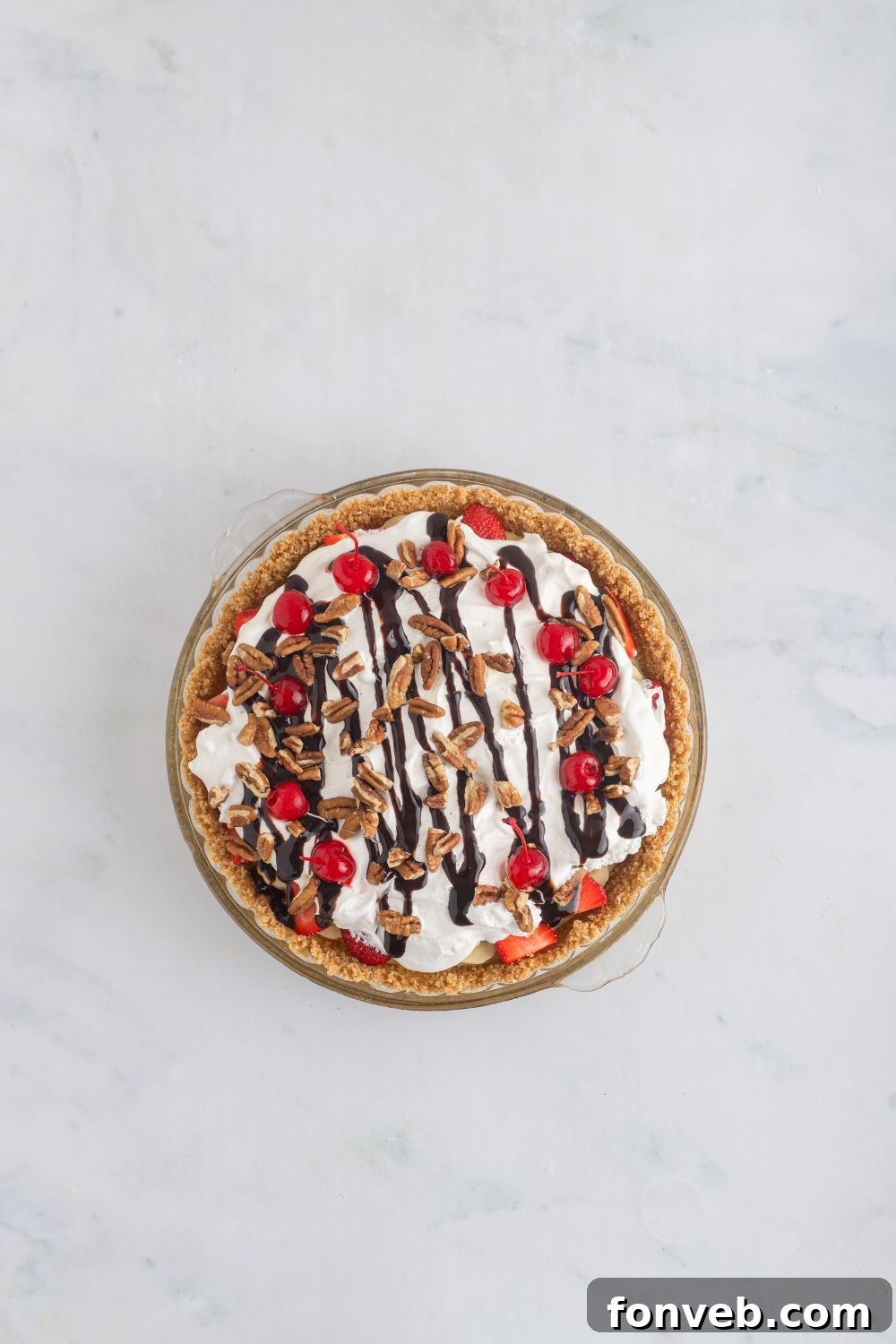 A fully assembled and chilled No Bake Banana Split Pie waiting on a table, ready for its final garnishes.