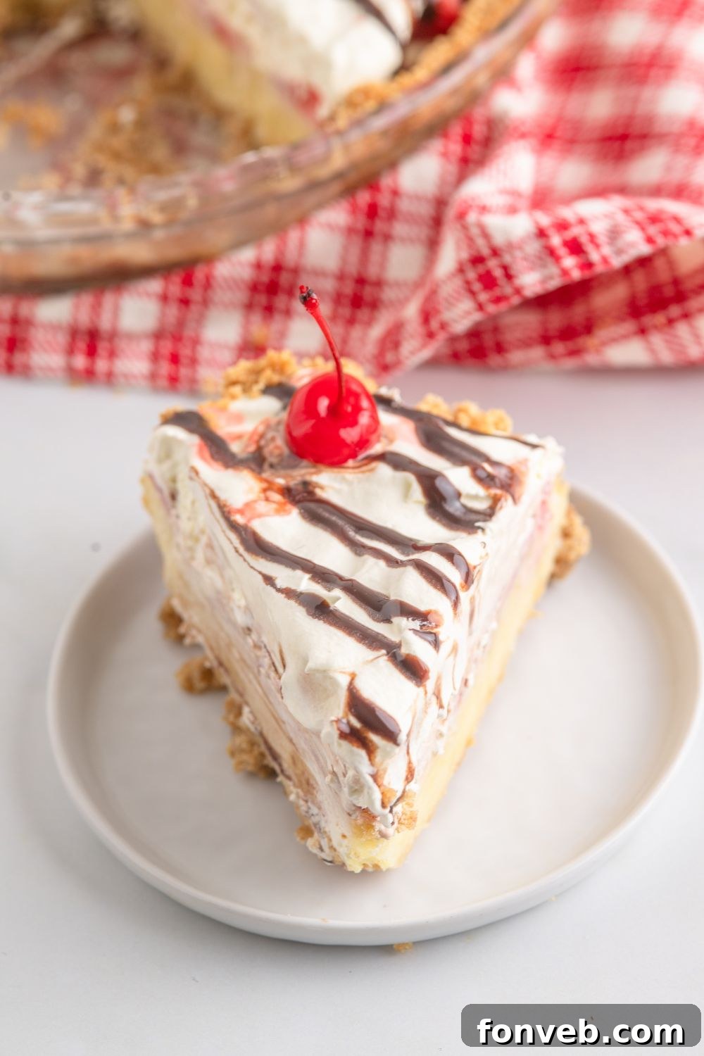 A delectable slice of No Bake Banana Split Pie neatly presented on a plate.