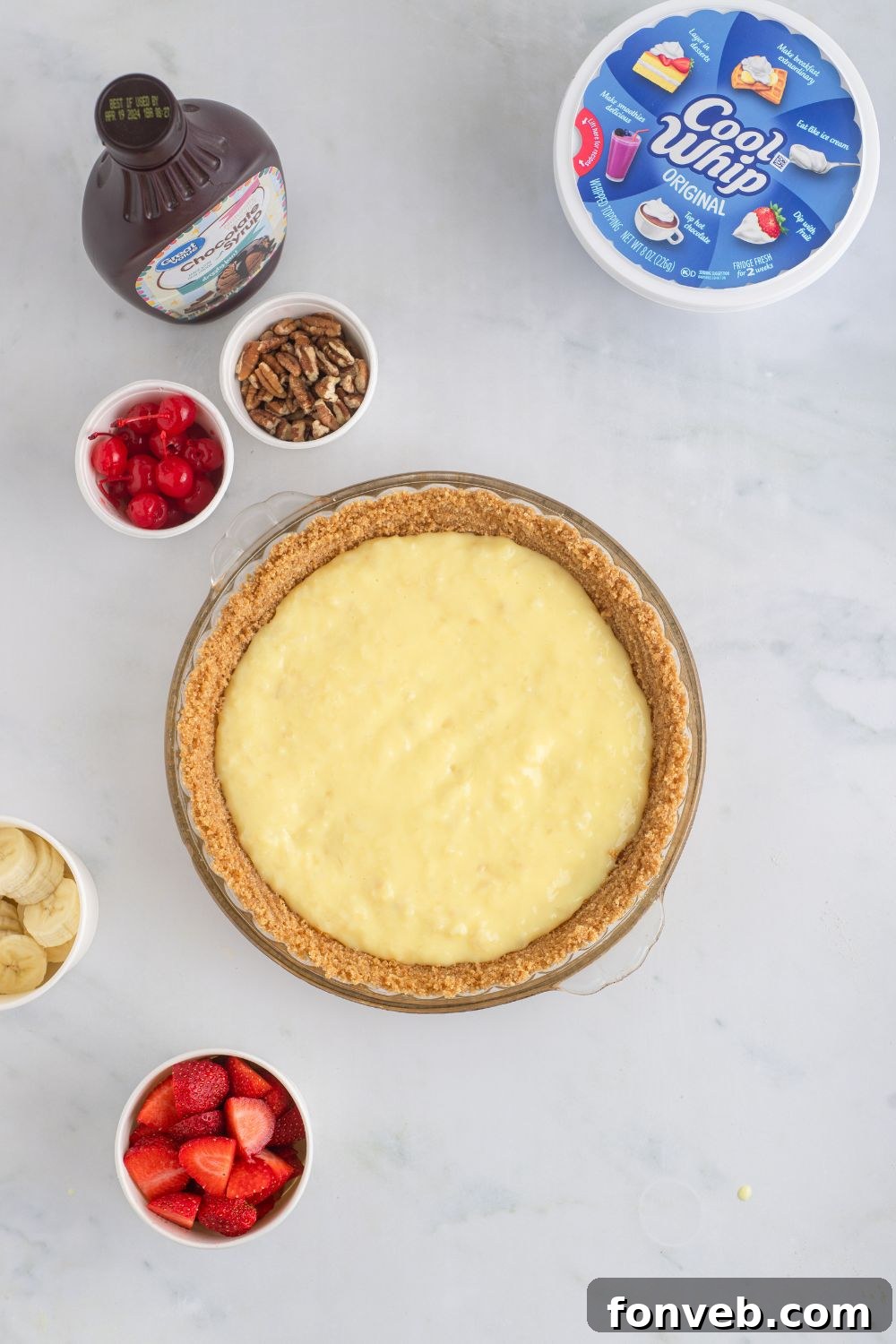 The smooth, creamy pie filling perfectly spread into a golden-brown pie crust, sitting on a table.