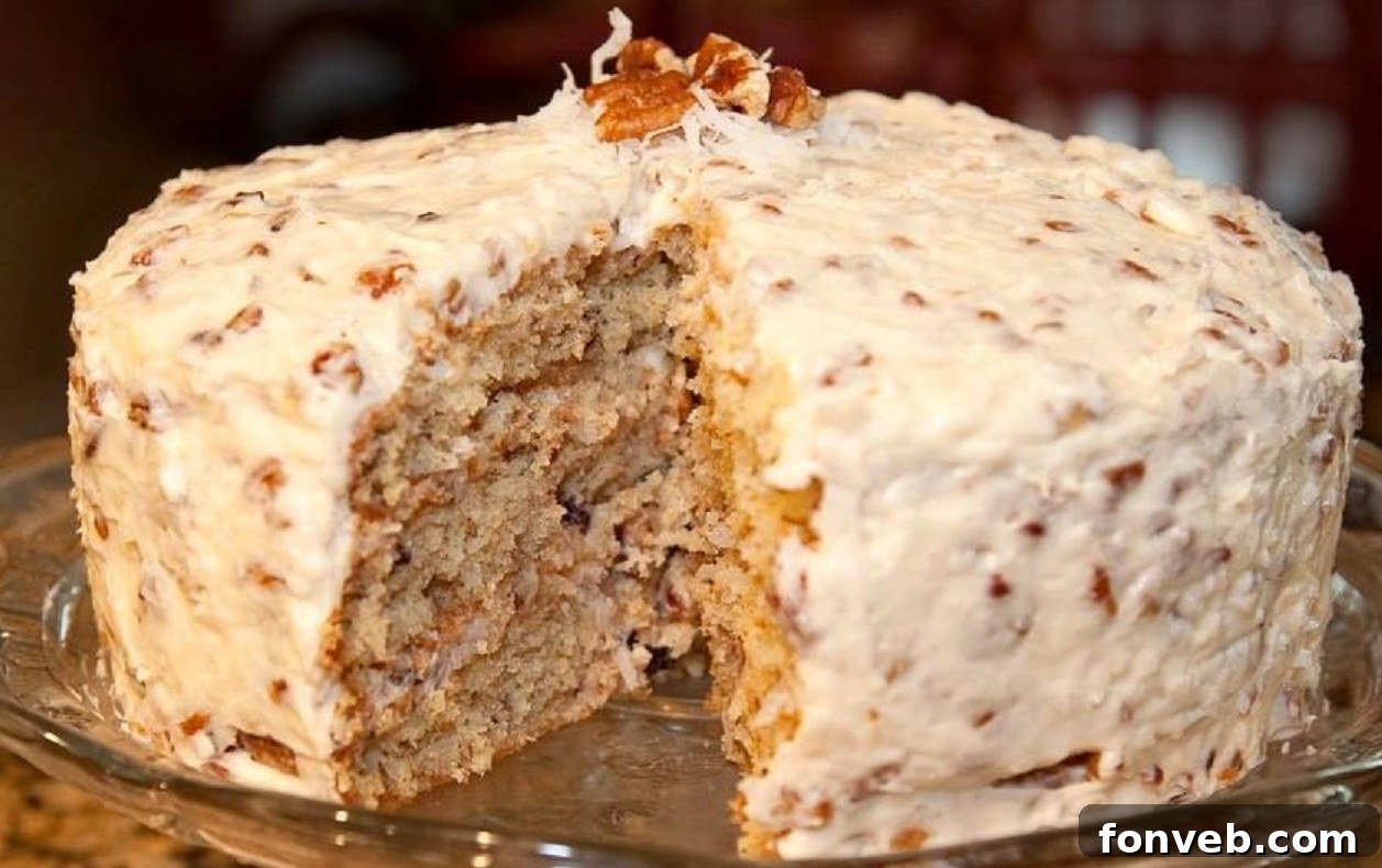 Slice of Easy Italian Cream Cake, showcasing its layers of cake, pecans, coconut, and cream cheese frosting
