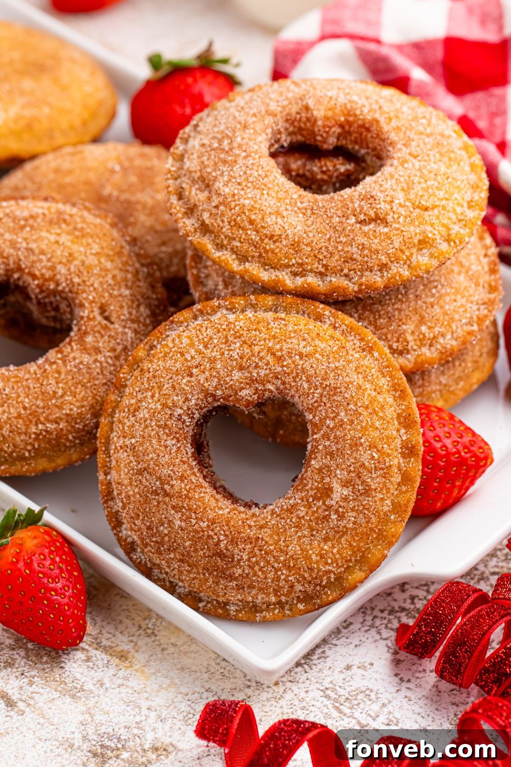 Uncrustables on a plate with hearts cut out and strawberries around table 